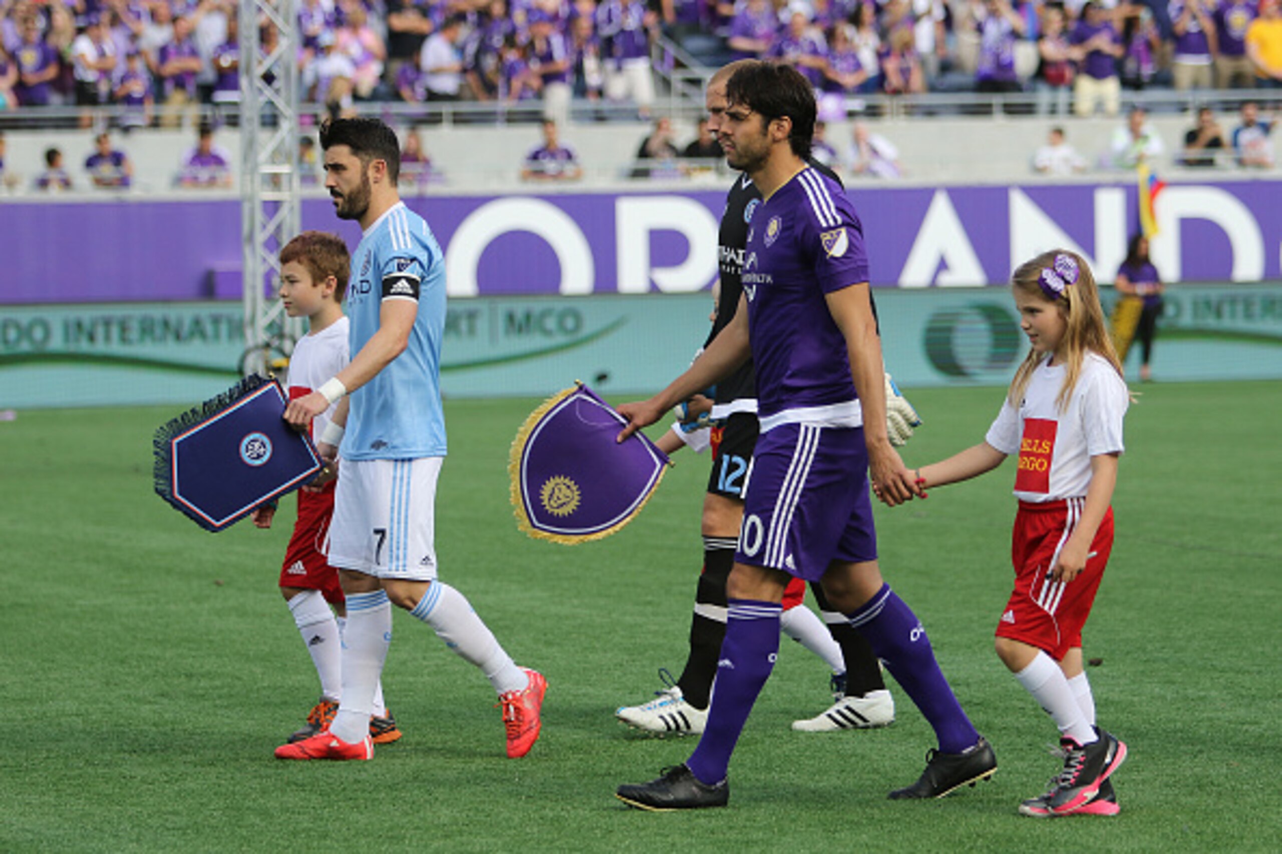 ORLANDO, FL - MARCH 08:  Team captains David Villa #7 of New York City FC and Kaka #10 of Orlando City SC leads their respective teams out during introductions prior to an MLS soccer match between the New York City FC and the Orlando City SC at the Orland