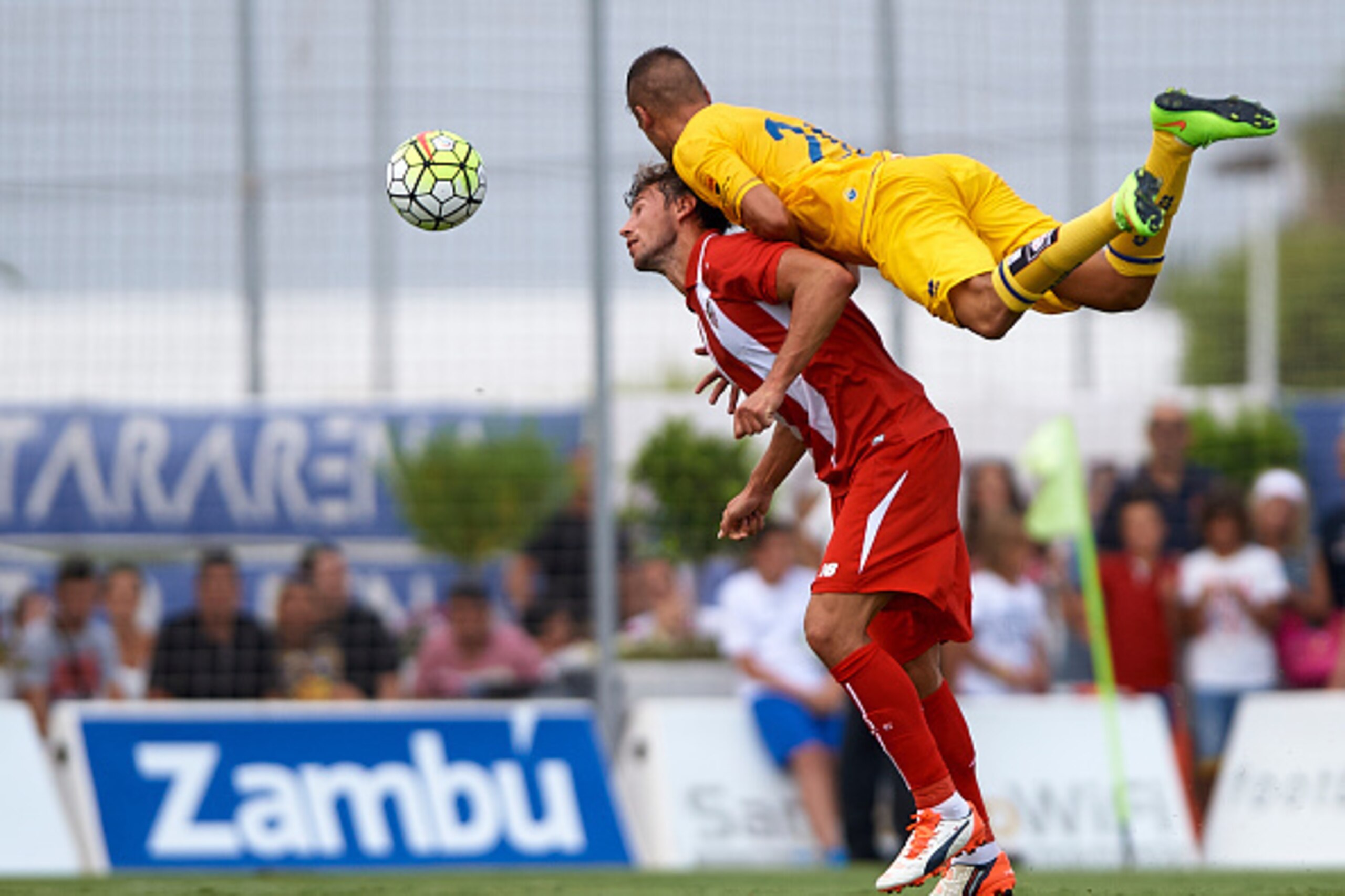 SAN PEDRO DE PINATAR, SPAIN - JULY 19: Grzegorz Krychowiak of Sevilla battle for the ball with Marc Nierga (R) of Alcorcon during a Pre Season Friendly match between Sevilla and Alcorcon at Pinatar Arena Stadium on July 19, 2015 in San Pedro de Pinatar, S