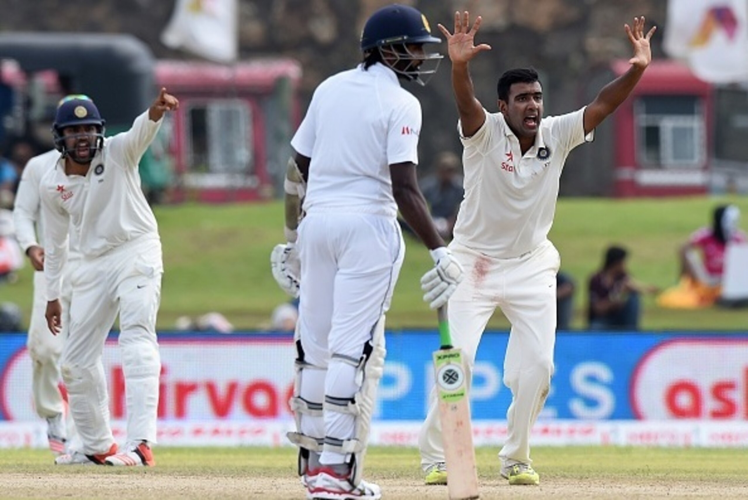 Indian cricketer Ravichandran Ashwin (R) successfully appeals for a Leg Before Wicket (LBW) decision against Sri Lankan cricketer Rangana Herath during the first day of the opening Test match between Sri Lanka and India at the Galle International Cricket 