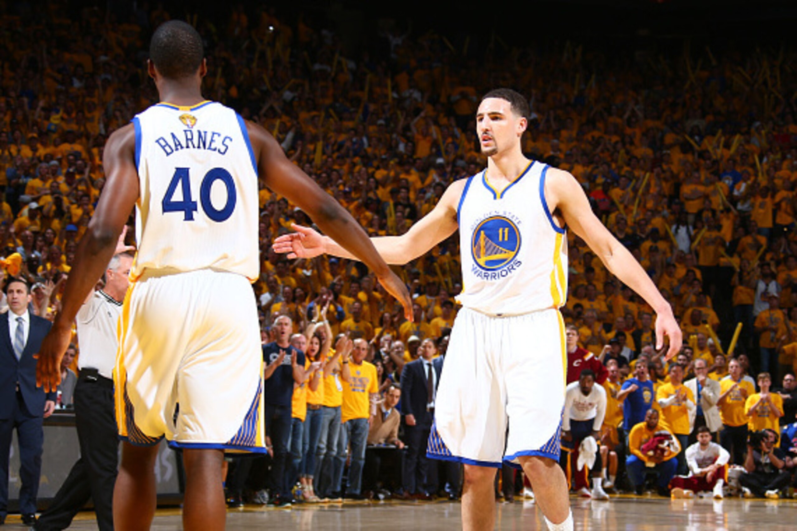 OAKLAND, CA - JUNE 14: Teammates Harrison Barnes #40 of the Golden State Warriors and Klay Thompson #11 of the Golden State Warriors high-five during Game Five of the 2015 NBA Finals on June 14, 2015 at Oracle Arena in Oakland, California. NOTE TO USER: U