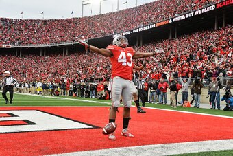 COLUMBUS, OH - NOVEMBER 29:  Darron Lee #43 of the Ohio State Buckeyes celebrates after running back a fumble recovery for a touchdown against the Michigan Wolverines at Ohio Stadium on November 29, 2014 in Columbus, Ohio. Ohio State defeated Michigan 42-