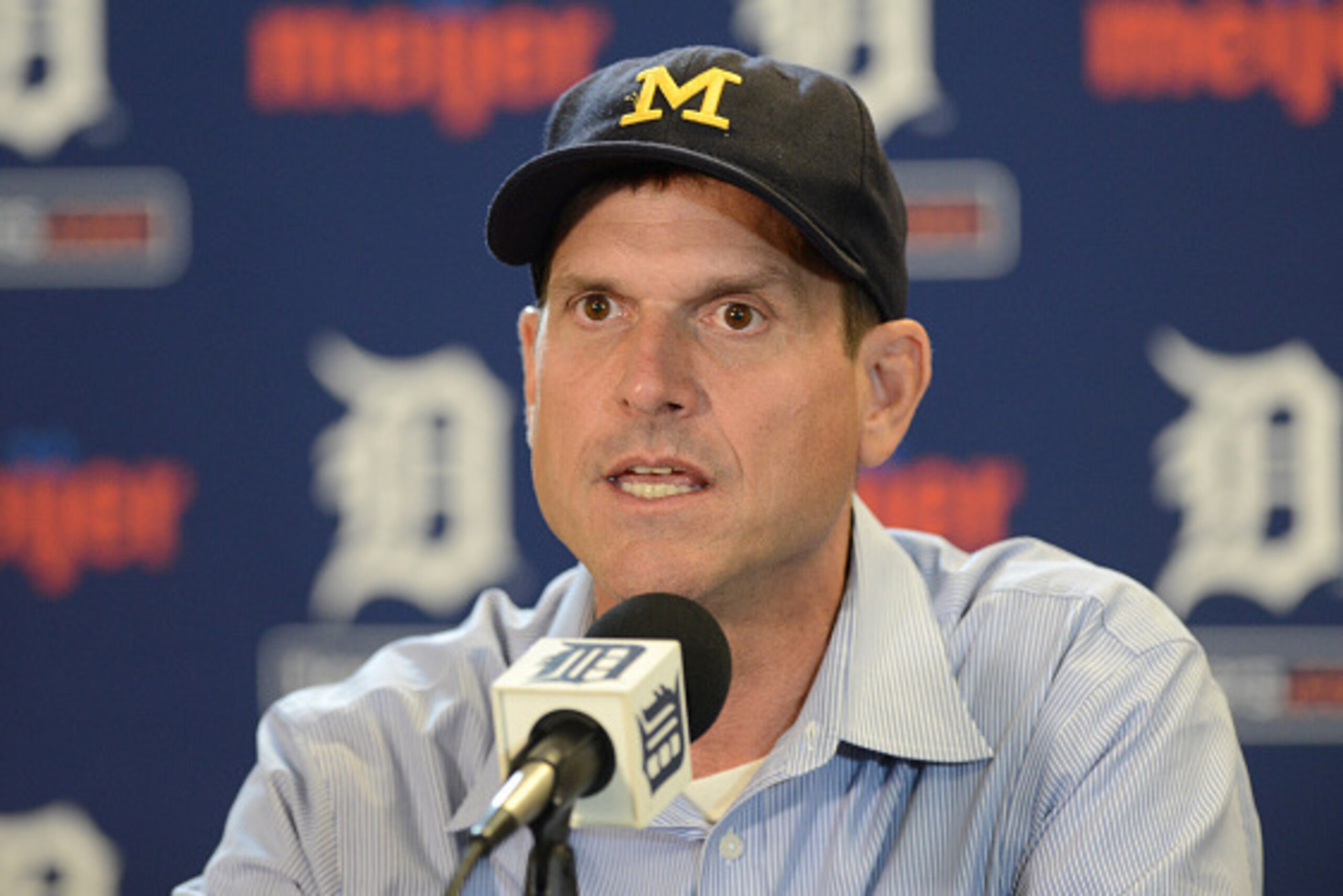 DETROIT, MI - JUNE 30:  University of Michigan head football coach Jim Harbaugh looks on while talking to the media prior to the Major League Baseball game between the Pittsburgh Pirates and the Detroit Tigers at Comerica Park on June 30, 2015 in Detroit,