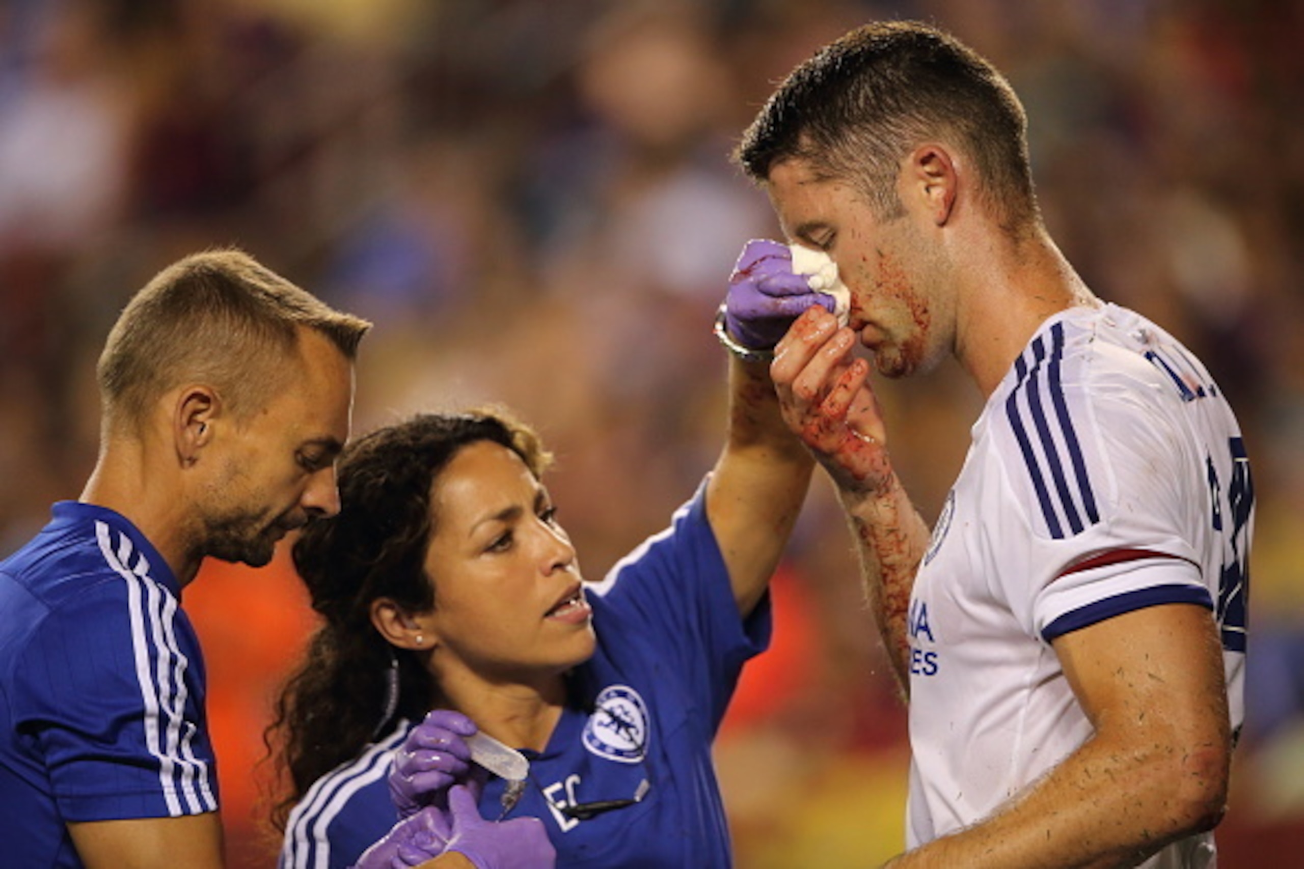 LANDOVER, MD - JULY 28:  Chelsea first-team doctor Eva Carneiro attends to Gary Cahill of Chelsea who suffered a bloody nose following scoring the goal which tied the game 2-2 during the International Champions Cup match between Barcelona and Chelsea at F