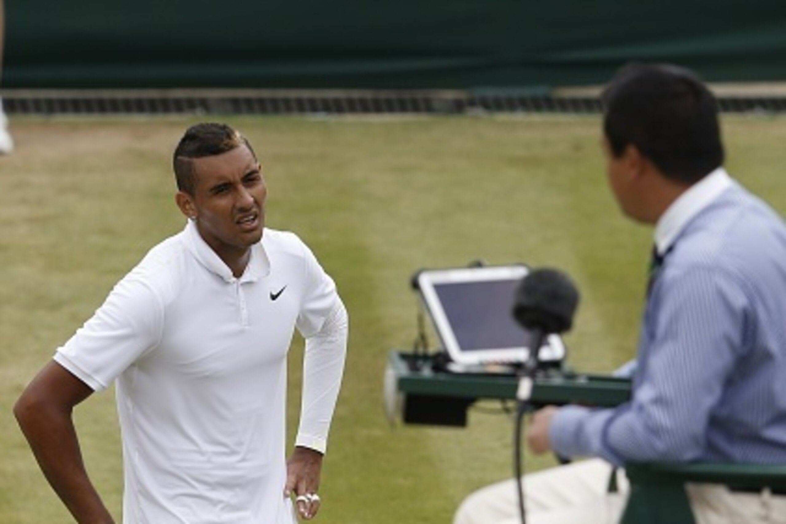Australia's Nick Kyrgios (L) talks with the umpire about a line call in a point against France's Richard Gasquet during their men's singles fourth round match on day seven of the 2015 Wimbledon Championships at The All England Tennis Club in Wimbledon, so