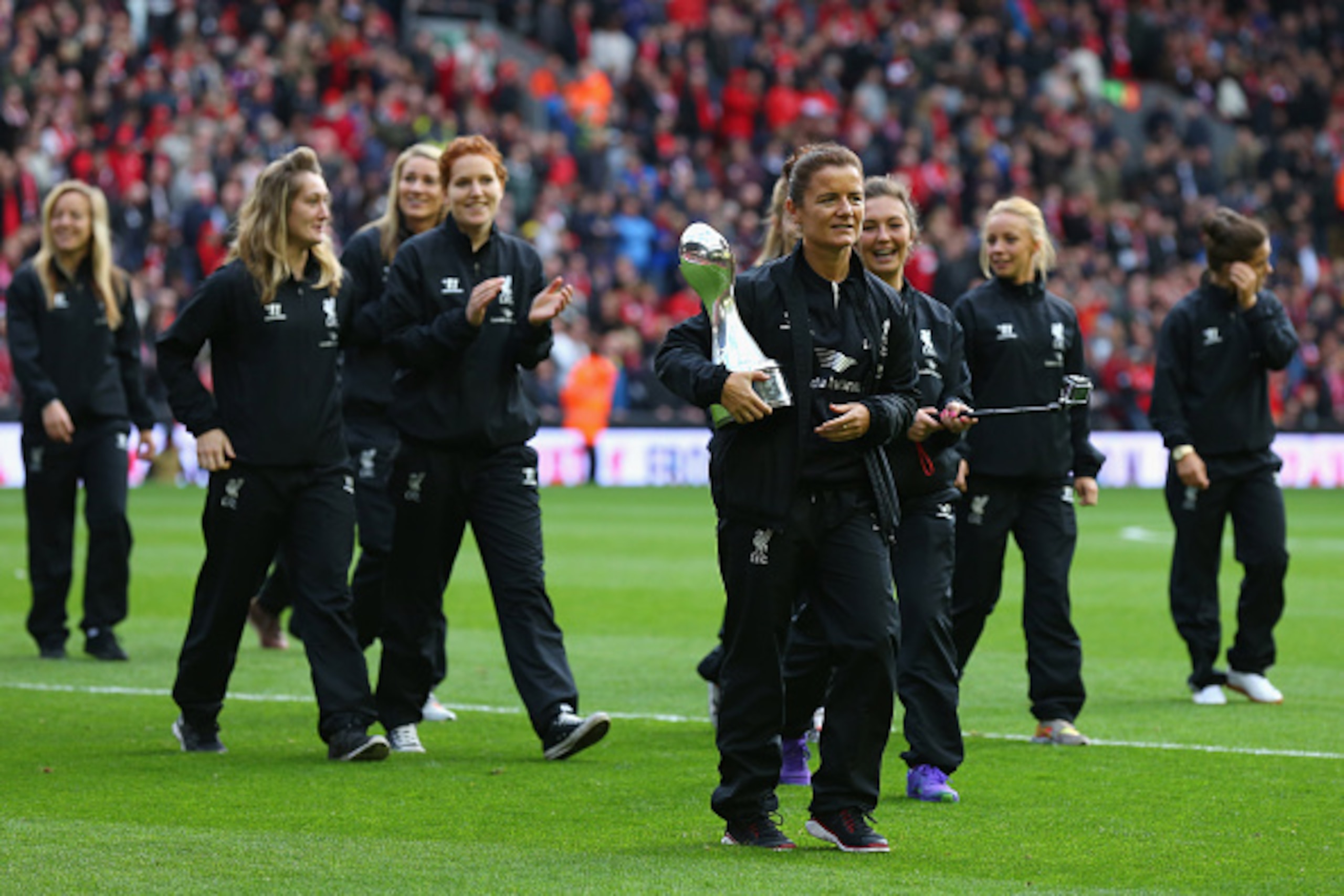 LIVERPOOL, ENGLAND - OCTOBER 25:  The Liverpool women's football team parade the Women's Super League trophy at half time during the Barclays Premier League match between Liverpool and Hull City at Anfield on October 25, 2014 in Liverpool, England.  (Phot