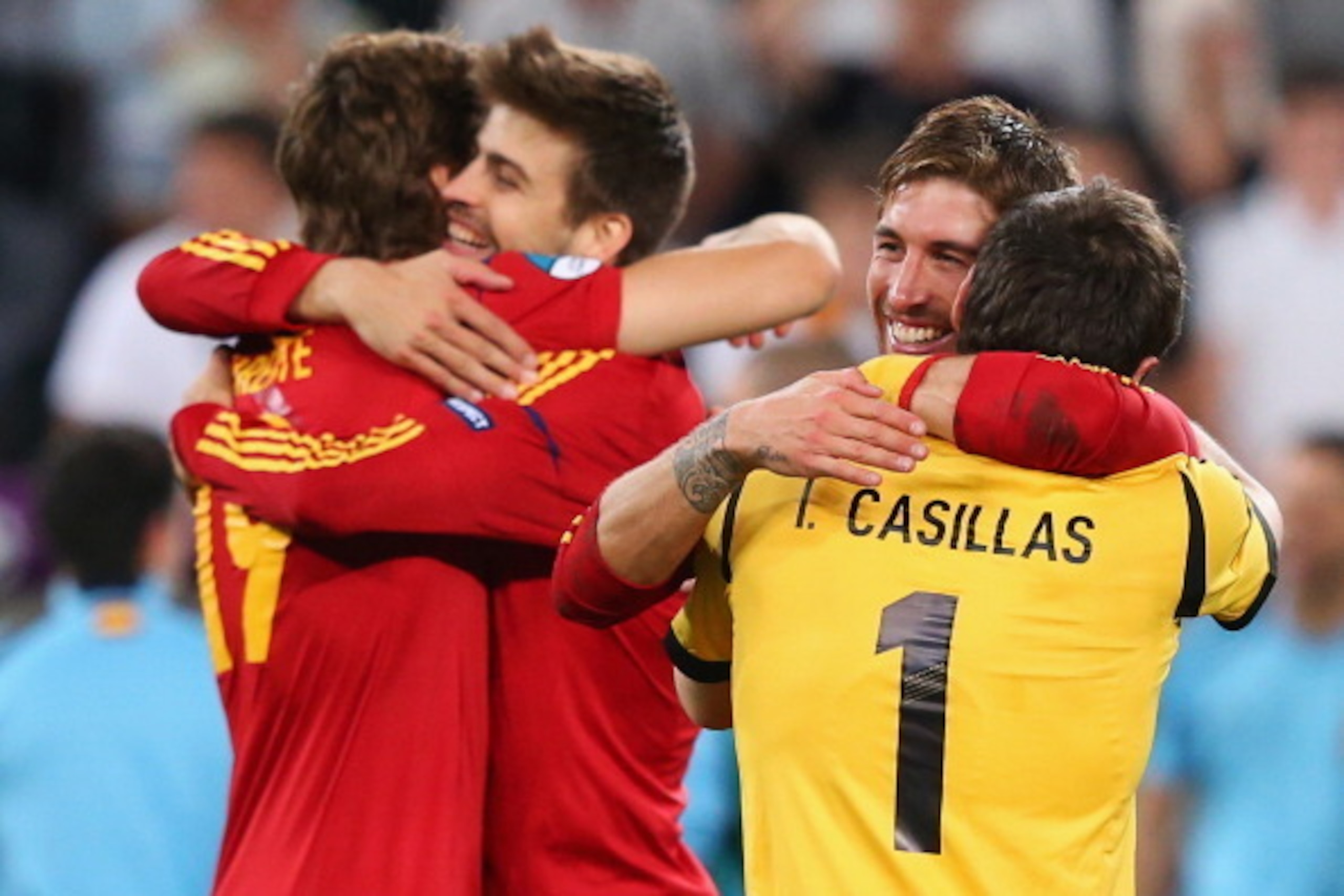 DONETSK, UKRAINE - JUNE 27: Fernando Llorente of Spain hugs team mate Gerard Pique (L) and Sergio Ramos hugs Iker Casillas after victory during the UEFA EURO 2012 semi final match between Portugal and Spain at Donbass Arena on June 27, 2012 in Donetsk, U DONETSK, UKRAINE - JUNE 27: Fernando Llorente of Spain hugs team mate Gerard Pique (L) and Sergio Ramos hugs Iker Casillas after victory during the UEFA EURO 2012 semi final match between Portugal and Spain at Donbass Arena on June 27, 2012 in Donetsk, U