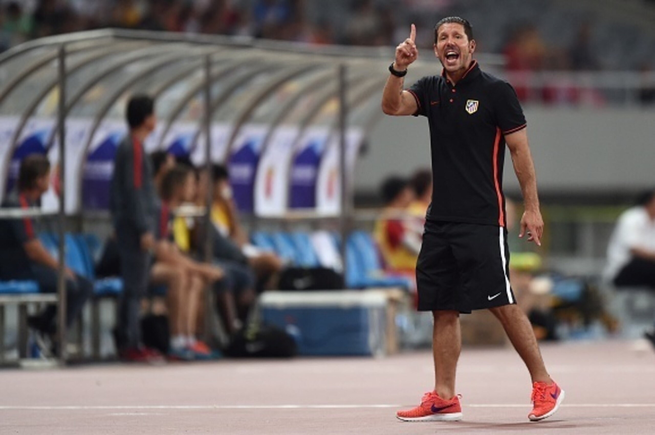 Atletico Madrid coach Diego Simeone gestures during a friendly football match between Shanghai SIPG and Atletico Madrid in Shanghai on August 4, 2015. AFP PHOTO / JOHANNES EISELE        (Photo credit should read JOHANNES EISELE/AFP/Getty Images)