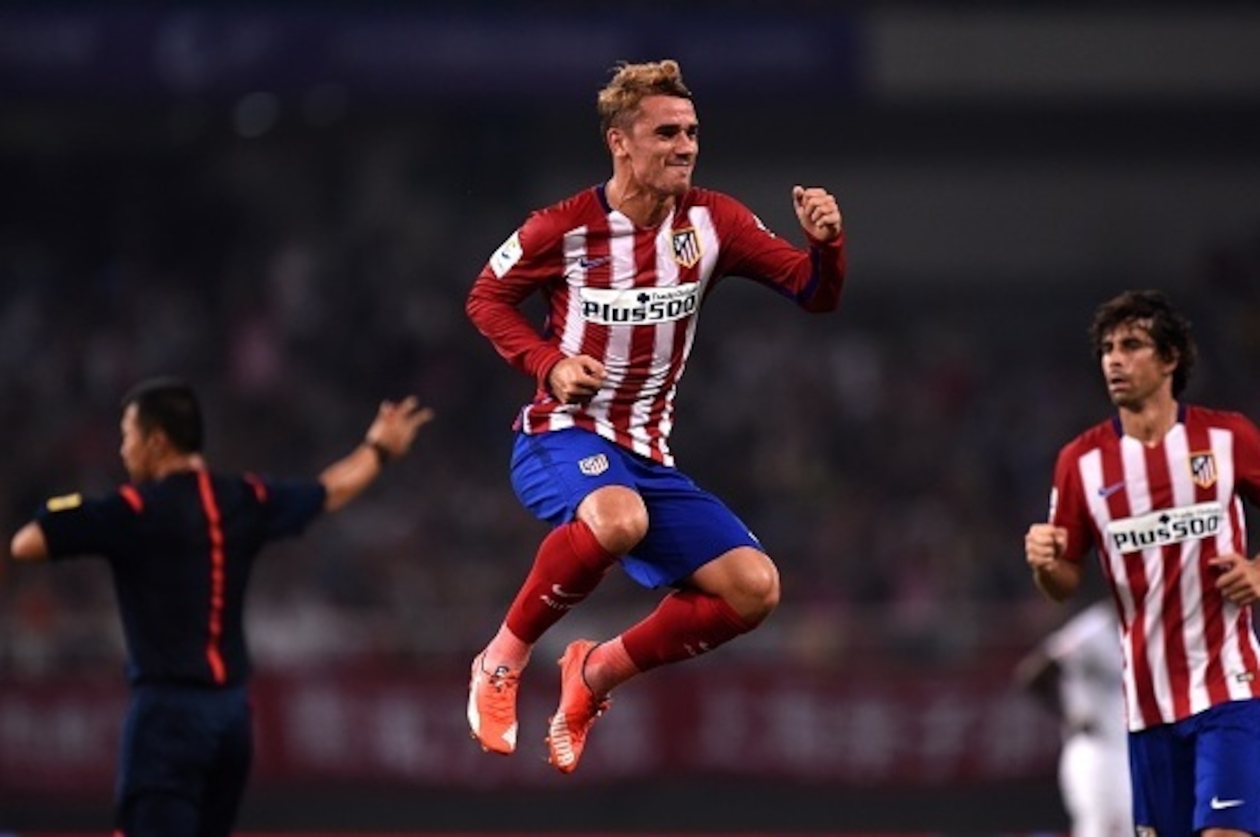 Atletico Madrid's French forward Antoine Griezmann (C) celebrates his second goal during a friendly football match between Shanghai SIPG and Atletico Madrid in Shanghai on August 4, 2015. AFP PHOTO / JOHANNES EISELE        (Photo credit should read JOHANN