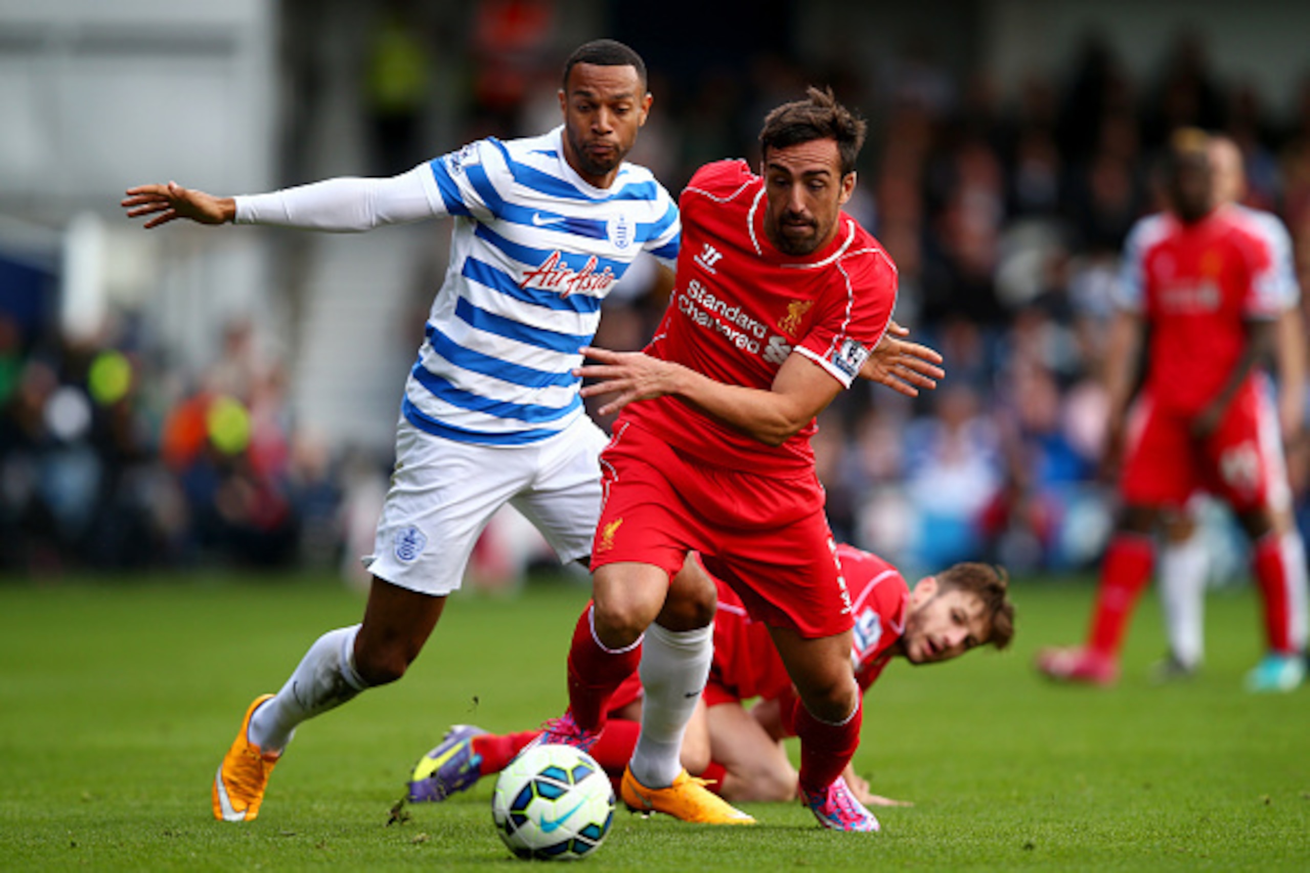 LONDON, ENGLAND - OCTOBER 19: Jose Enrique of Liverpool runs with the ball past Matt Phillips of QPR during the Barclays Premier League match between Queens Park Rangers and Liverpool at Loftus Road on October 19, 2014 in London, England. (Photo by Cliv LONDON, ENGLAND - OCTOBER 19: Jose Enrique of Liverpool runs with the ball past Matt Phillips of QPR during the Barclays Premier League match between Queens Park Rangers and Liverpool at Loftus Road on October 19, 2014 in London, England. (Photo by Cliv