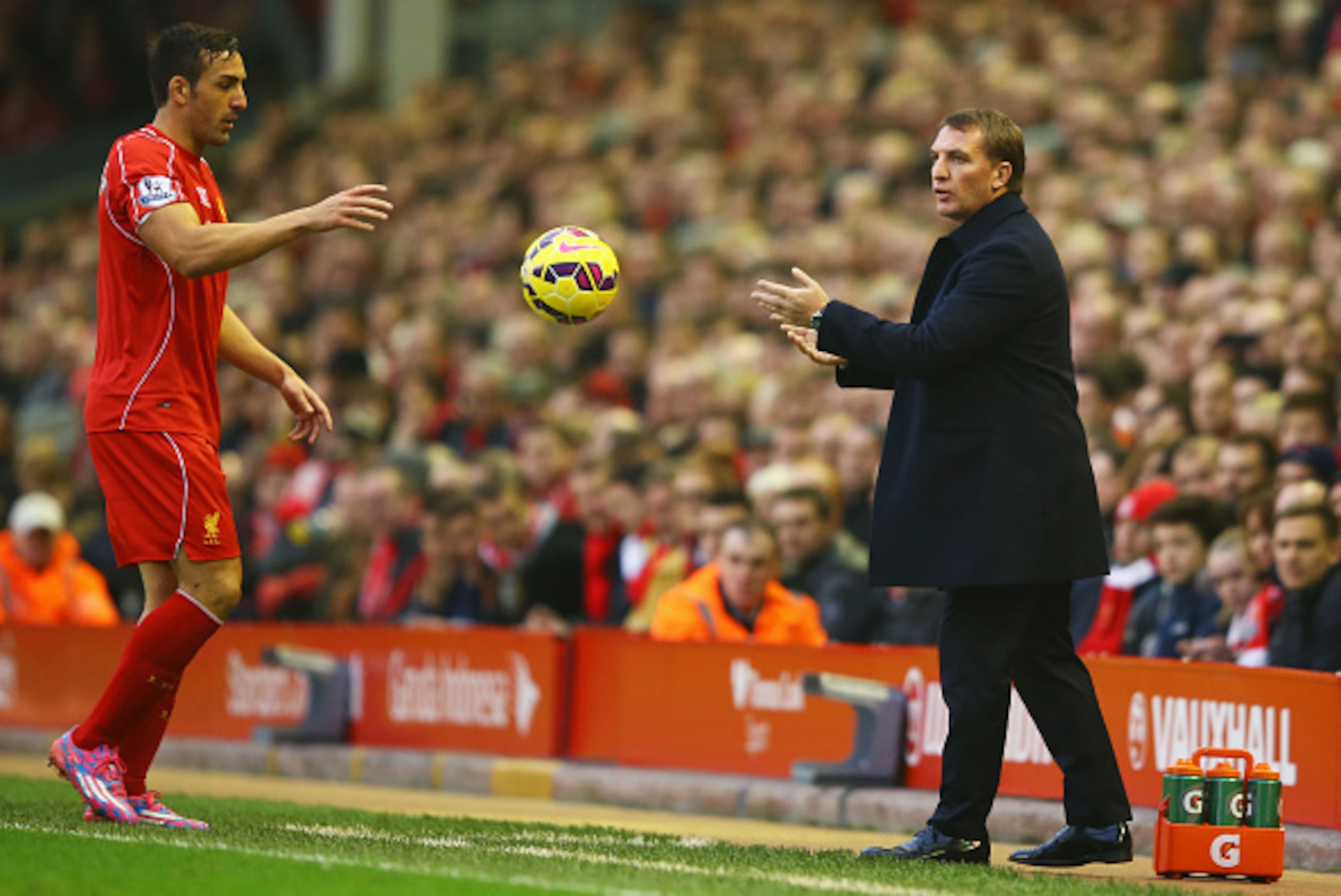 LIVERPOOL, ENGLAND - NOVEMBER 29: Brendan Rodgers manager of Liverpool throws the ball to Jose Enrique of Liverpool during the Barclays Premier League match between Liverpool and Stoke City at Anfield on November 29, 2014 in Liverpool, England. (Photo b LIVERPOOL, ENGLAND - NOVEMBER 29: Brendan Rodgers manager of Liverpool throws the ball to Jose Enrique of Liverpool during the Barclays Premier League match between Liverpool and Stoke City at Anfield on November 29, 2014 in Liverpool, England. (Photo b