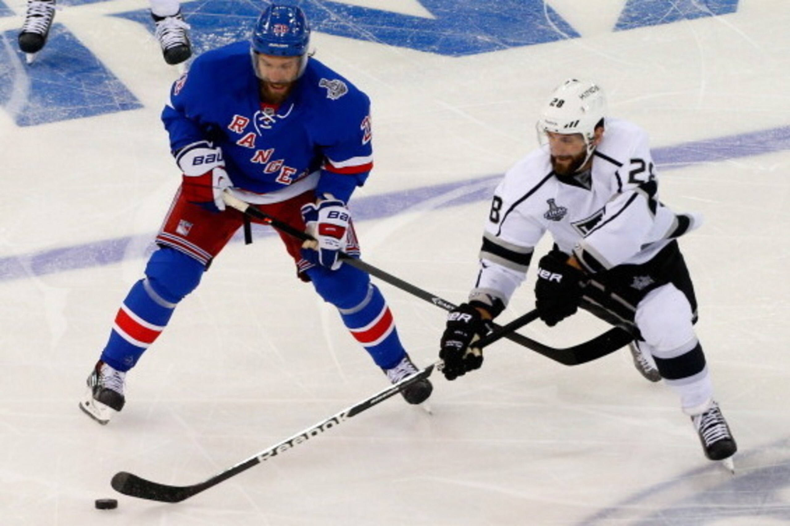 NEW YORK, NY - JUNE 09:  Jarret Stoll #28 of the Los Angeles Kings in action against Dominic Moore #28 of the New York Rangers during Game Three of the 2014 NHL Stanley Cup Final at Madison Square Garden on June 9, 2014 in New York, New York.  (Photo by J