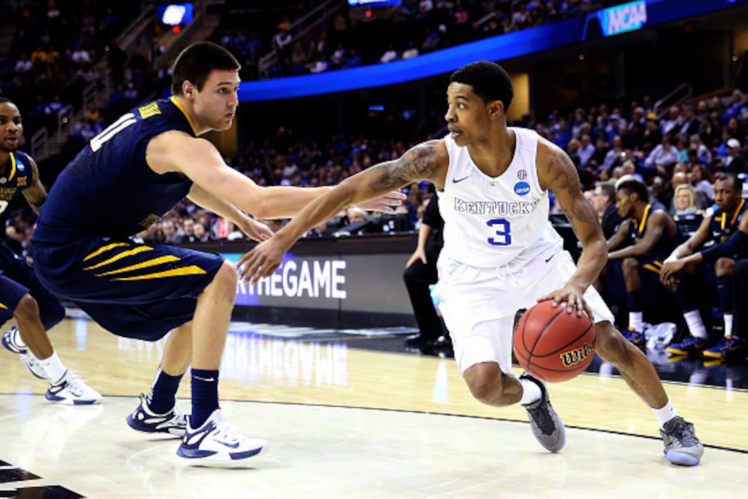 CLEVELAND, OH - MARCH 26: Tyler Ulis #3 of the Kentucky Wildcats handles the ball against Nathan Adrian #11 of the West Virginia Mountaineers in the second half during the Midwest Regional semifinal of the 2015 NCAA Men's Basketball Tournament at Quicken 