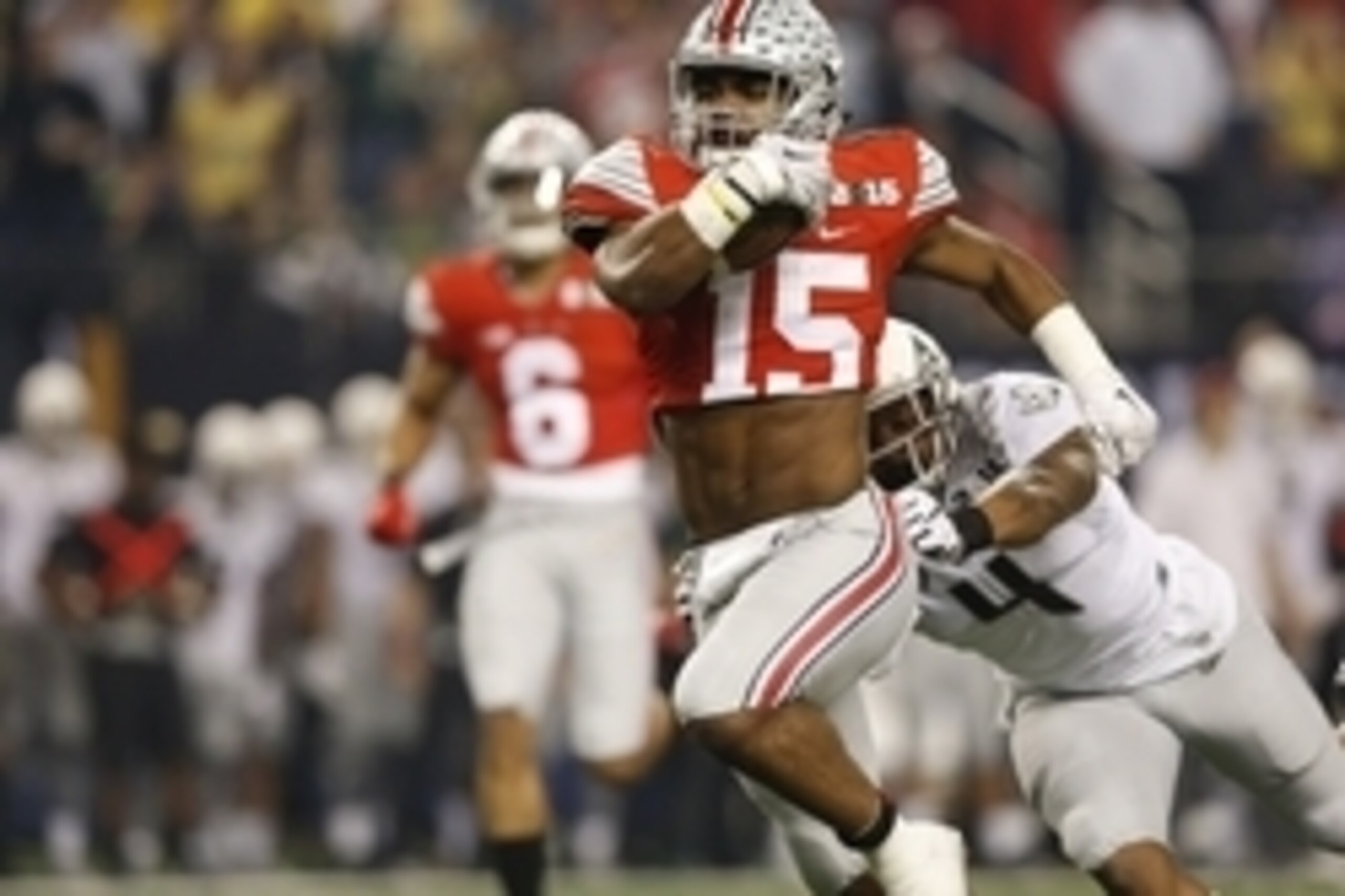 Jan 12, 2015; Arlington, TX, USA; Ohio State Buckeyes running back Ezekiel Elliott (15) runs with the ball against Oregon Ducks defensive back Erick Dargan (4) during the first quarter in the 2015 CFP National Championship Game against the Oregon Ducks at