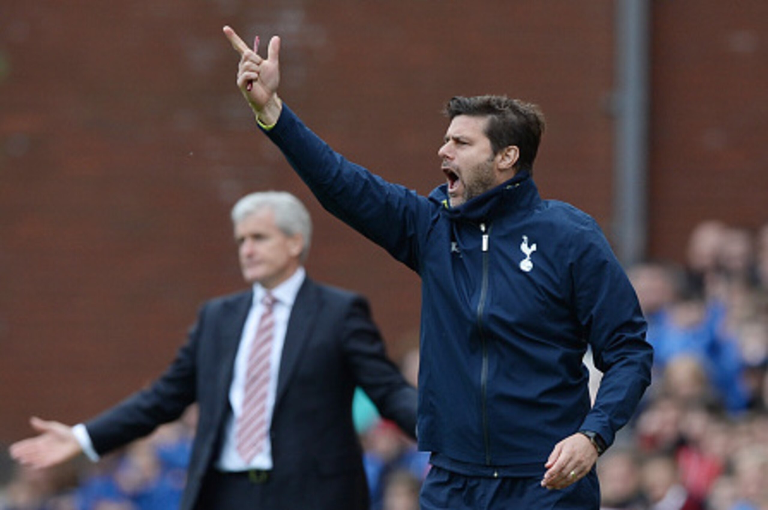 STOKE ON TRENT, ENGLAND - MAY 09: Mauricio Pochettino manager of Spurs reacts as Mark Hughes manager of Stoke City looks on during the Barclays Premier League match between Stoke City and Tottenham Hotspur at Britannia Stadium on May 9, 2015 in Stoke on STOKE ON TRENT, ENGLAND - MAY 09: Mauricio Pochettino manager of Spurs reacts as Mark Hughes manager of Stoke City looks on during the Barclays Premier League match between Stoke City and Tottenham Hotspur at Britannia Stadium on May 9, 2015 in Stoke on