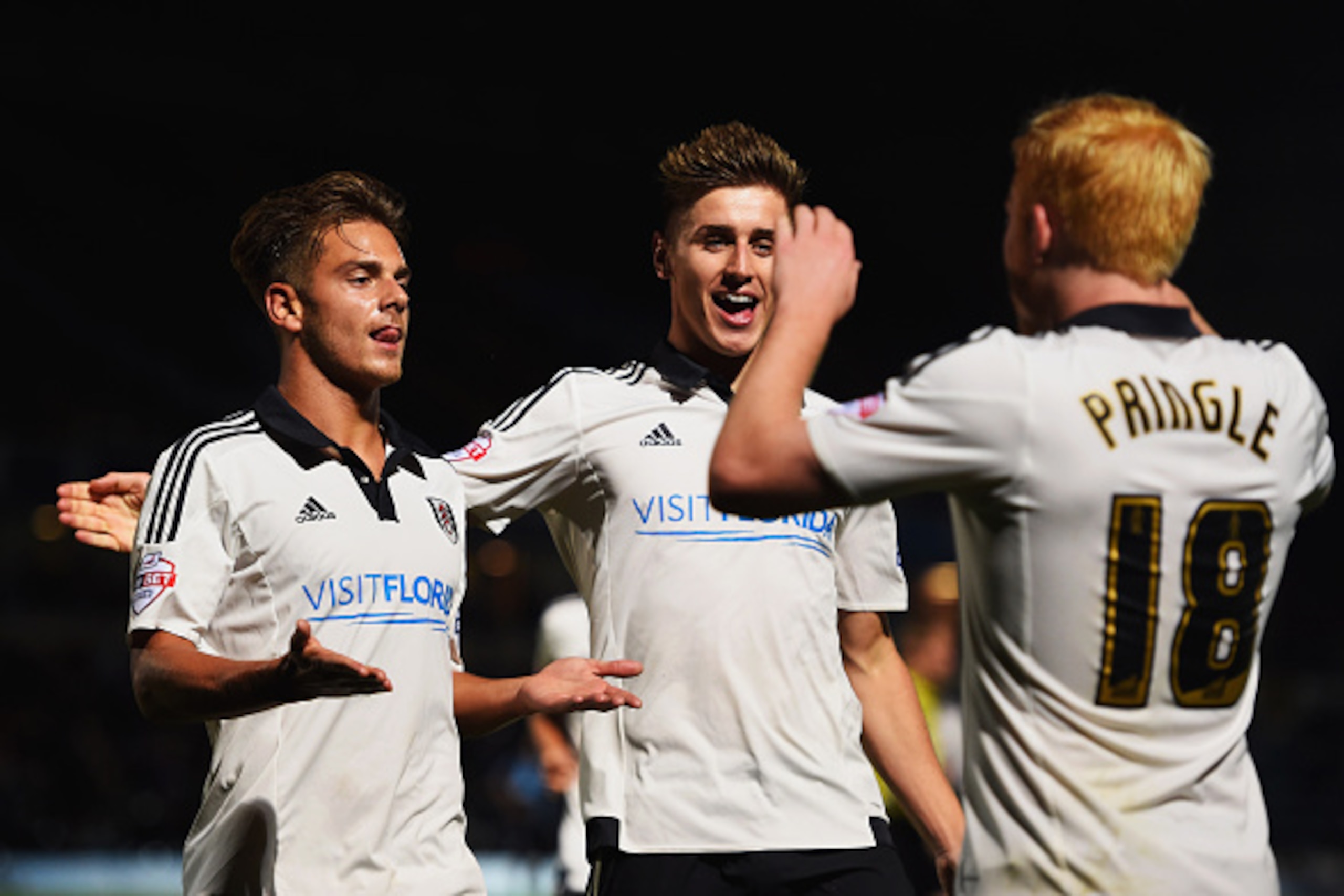 HIGH WYCOMBE, ENGLAND - AUGUST 11:  Goalscorer Alex Kacaniklic of Fulham (L) celebrates with goal provider Ben Pringle (18) as he scores their first goal during the Capital One Cup first round match between Wycombe Wanderers and Fulham at Adams Park on Au