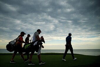 SHEBOYGAN, WI - AUGUST 13:  Tiger Woods of the United States walks ahead of Martin Kaymer of Germany and their caddies on the 16th hole during the first round of the 2015 PGA Championship at Whistling Straits on August 13, 2015 in Sheboygan, Wisconsin.  (