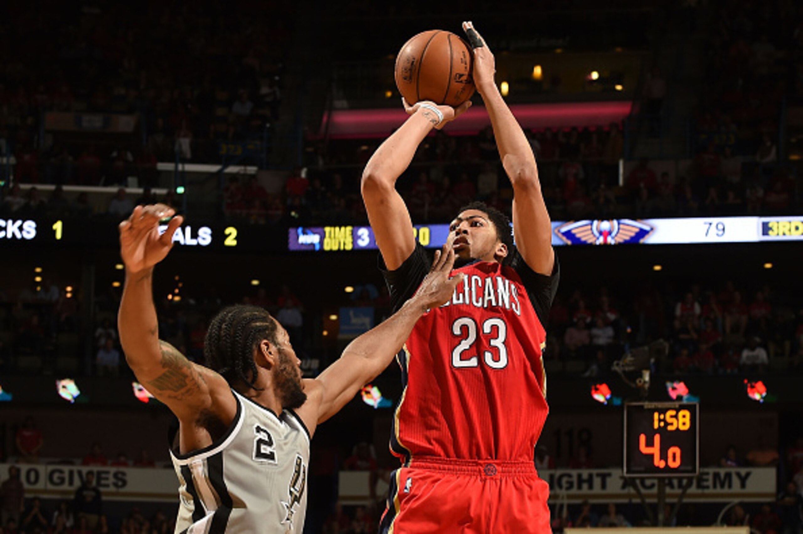 NEW ORLEANS, LA - APRIL 15:  Anthony Davis #23 of the New Orleans Pelicans is defended by Kawhi Leonard #2 of the San Antonio Spurs during the second half of a game at the Smoothie King Center on April 15, 2015 in New Orleans, Louisiana. NOTE TO USER: Use