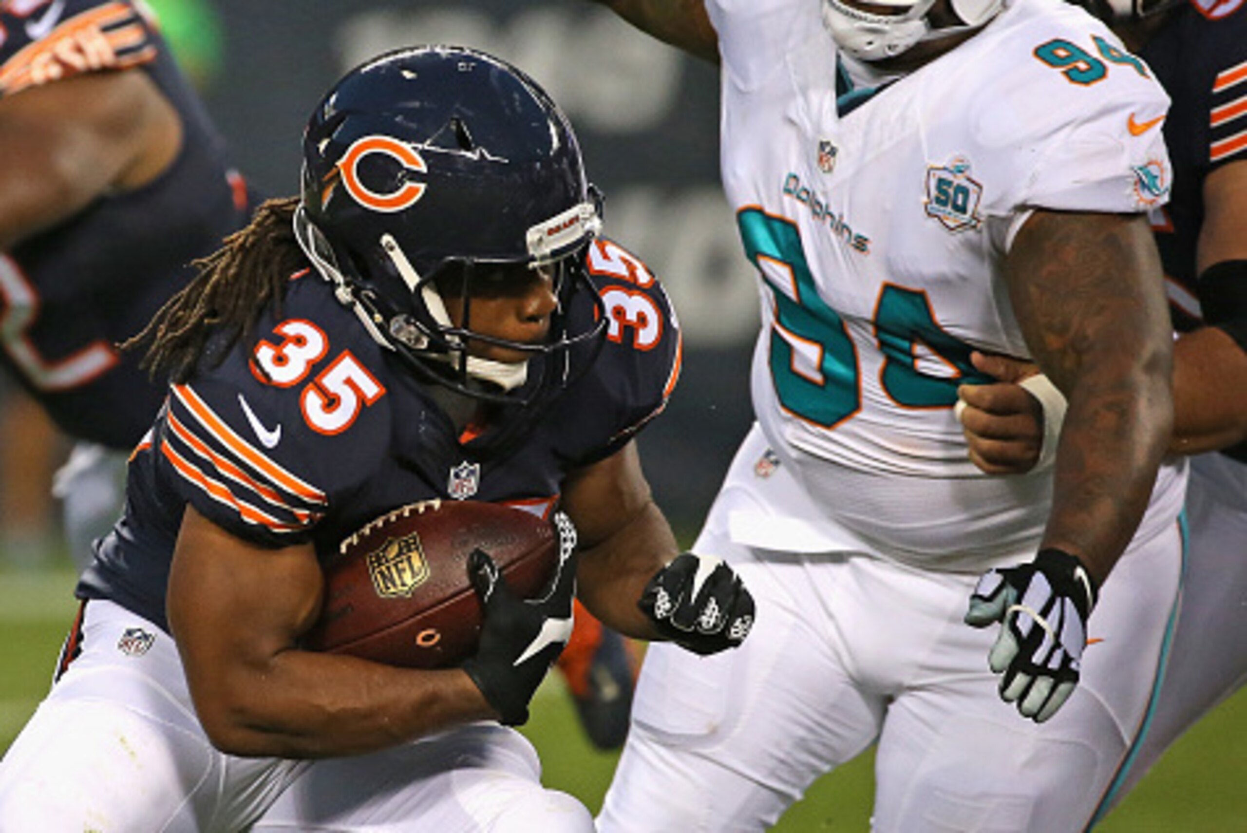 CHICAGO, IL - AUGUST 13: Jacquizz Rodgers #35 of the Chicago Bears is chased by C.J. Mosley #94 of the Miami Dolphins during a preseason game at Soldier Field on August 13, 2015 in Chicago, Illinois. (Photo by Jonathan Daniel/Getty Images)