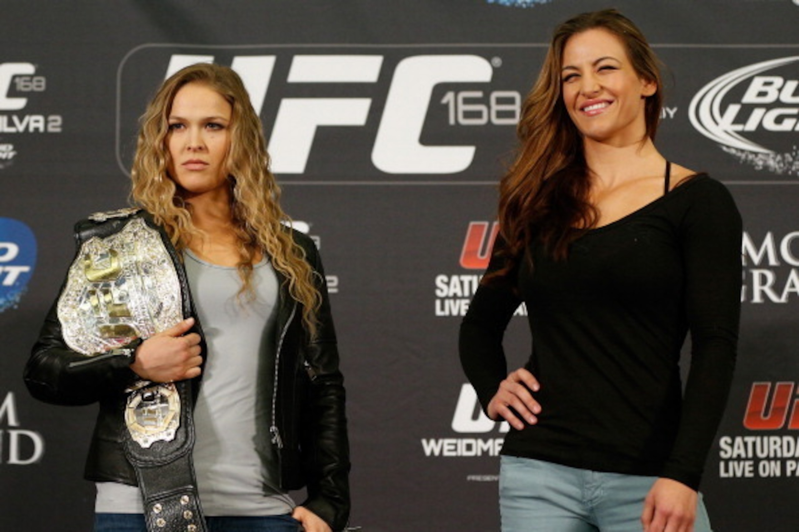 LAS VEGAS, NV - DECEMBER 26:  (L-R) Opponents Ronda Rousey and Miesha Tate pose for photos during the UFC 168 pre-fight press conference at the MGM Grand Hotel/Casino on December 26, 2013 in Las Vegas, Nevada. (Photo by Josh Hedges/Zuffa LLC/Zuffa LLC via
