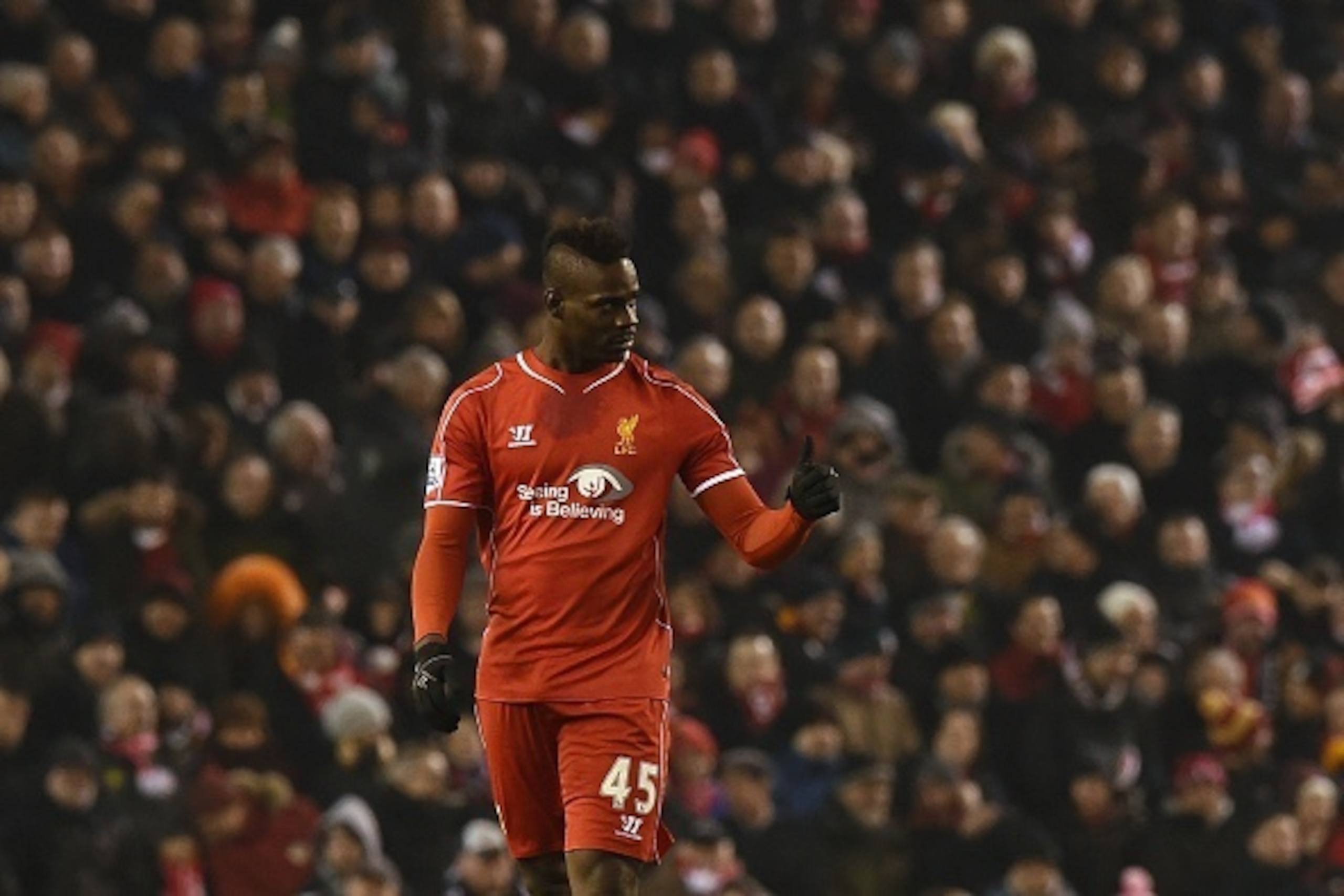 Liverpool's Italian striker Mario Balotelli gives a thumbs up after scoring Liverpool's third goal during the English Premier League football match between Liverpool and Tottenham Hotspur at the Anfield stadium in Liverpool, northwest England, on February
