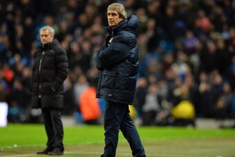 Chelsea's Portuguese manager Jose Mourinho (L) and Manchester City's Chilean manager Manuel Pellegrini (R) look on during the English FA Cup fifth round football match between Manchester City and Chelsea at The Etihad Stadium in Manchester, northwest Engl