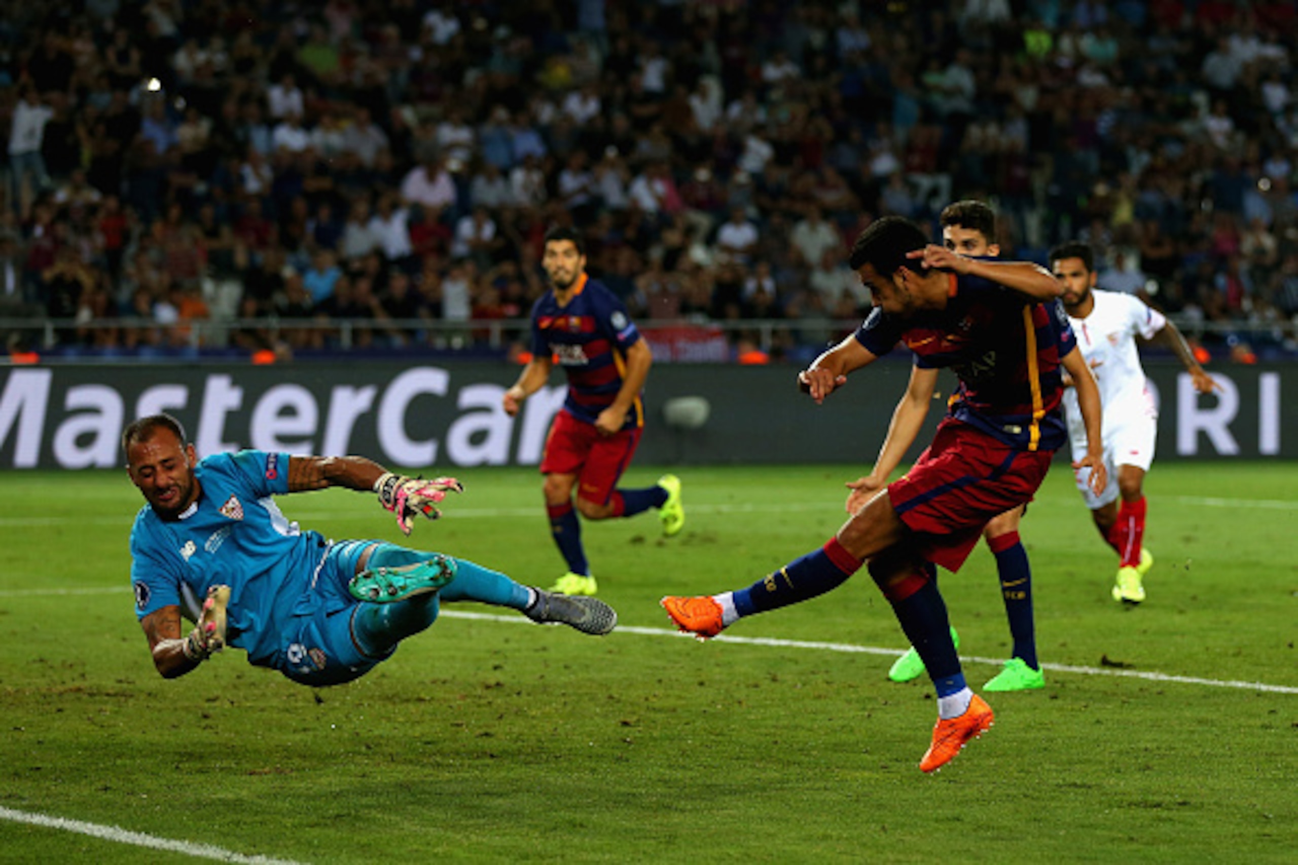 TBILISI, GEORGIA - AUGUST 11:  Pedro of Barcelona scores their fifth goal past Beto of Sevilla in extra time during the UEFA Super Cup between Barcelona and Sevilla FC at Dinamo Arena on August 11, 2015 in Tbilisi, Georgia.  (Photo by Chris Brunskill/Gett