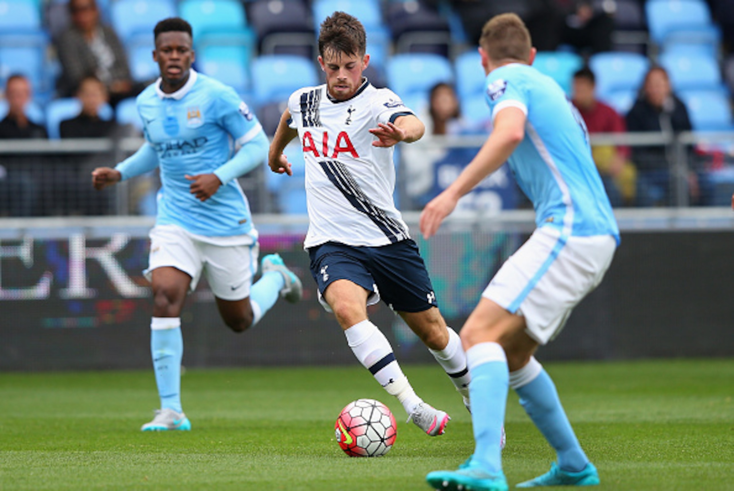 MANCHESTER, ENGLAND - AUGUST 14:  Kenny McEvoy of Tottenham Hotspur U21 runs at George Evans of Manchester City U21 during the Barclays U21 Premier League match between Manchester City U21 and Tottenham Hotspur U21 at The Academy Stadium on August 14, 201