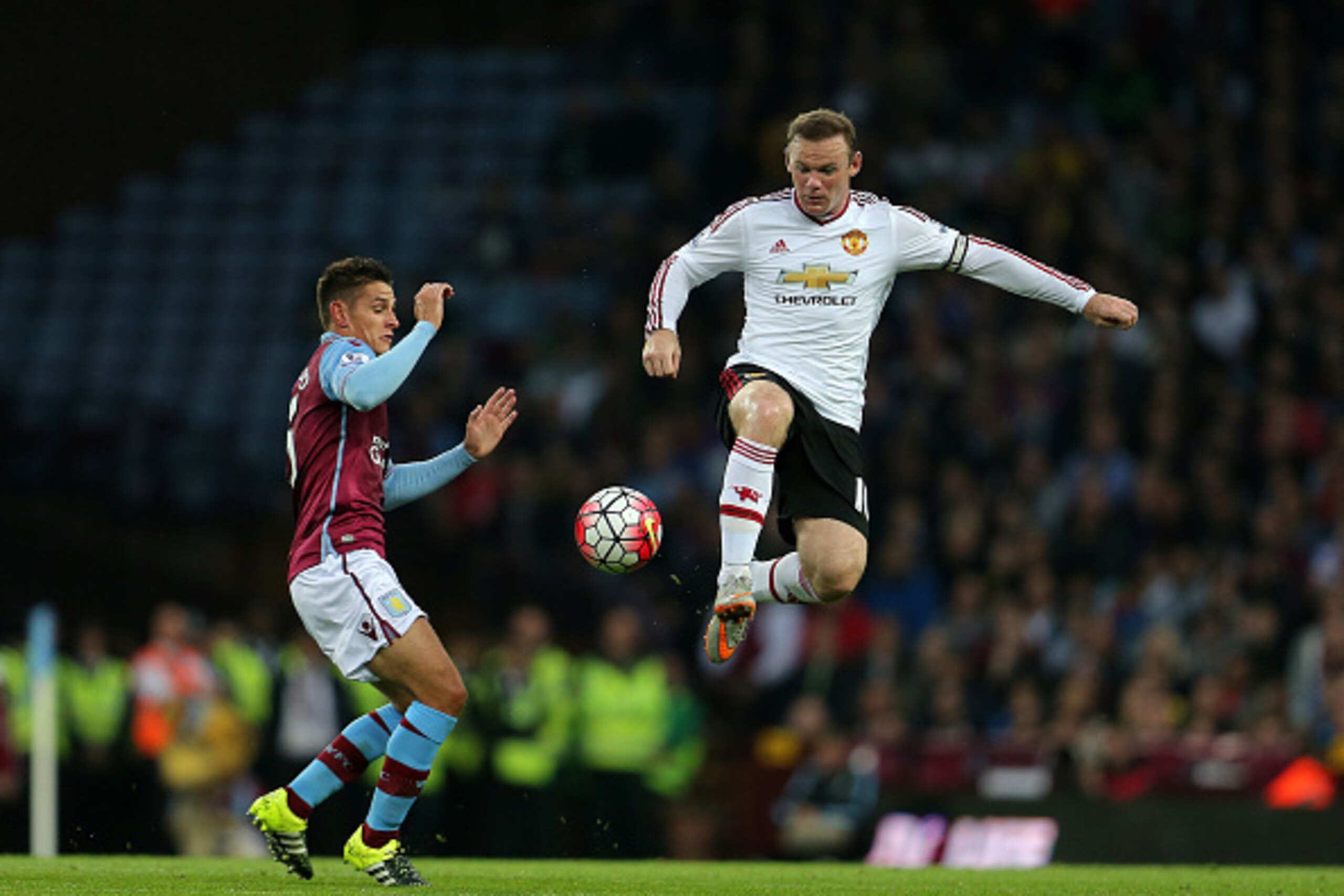 BIRMINGHAM, ENGLAND - AUGUST 14:  Ashley Westwood of Aston Villa and Wayne Rooney of Manchester United during the Barclays Premier League match between Aston Villa and Manchester United at Villa Park on August 14, 2015 in Birmingham, England.  (Photo by J