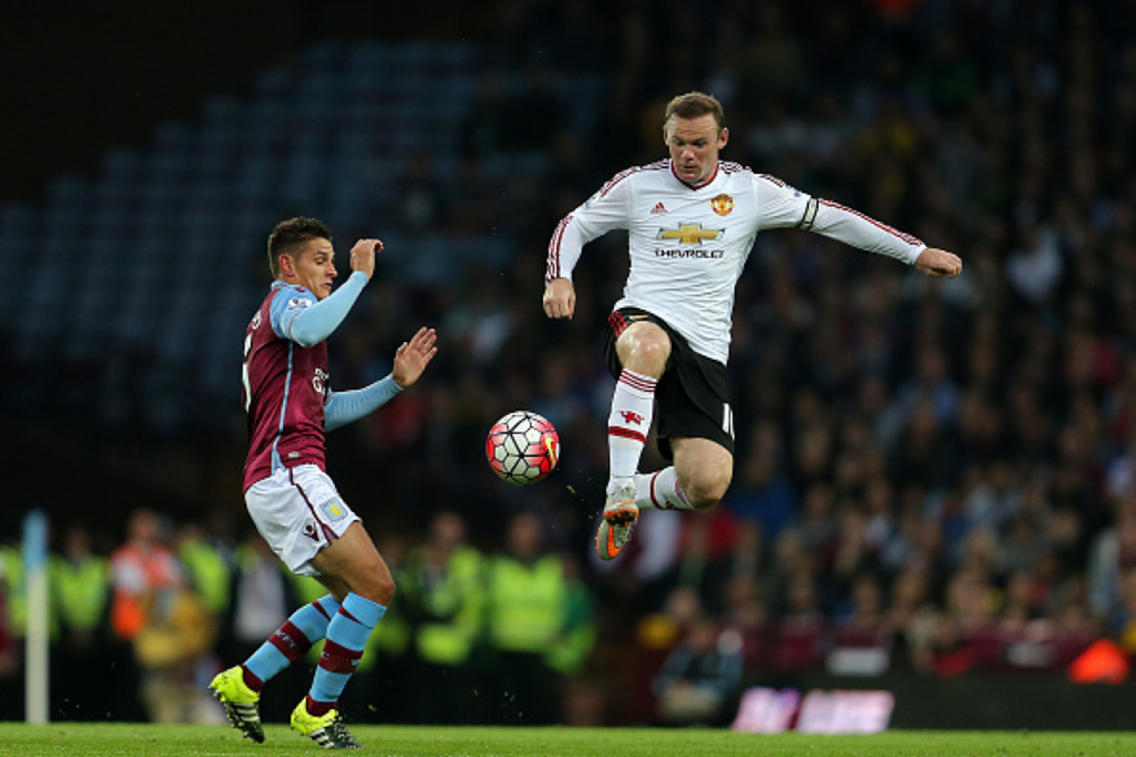 BIRMINGHAM, ENGLAND - AUGUST 14:  Ashley Westwood of Aston Villa and Wayne Rooney of Manchester United during the Barclays Premier League match between Aston Villa and Manchester United at Villa Park on August 14, 2015 in Birmingham, England.  (Photo by J