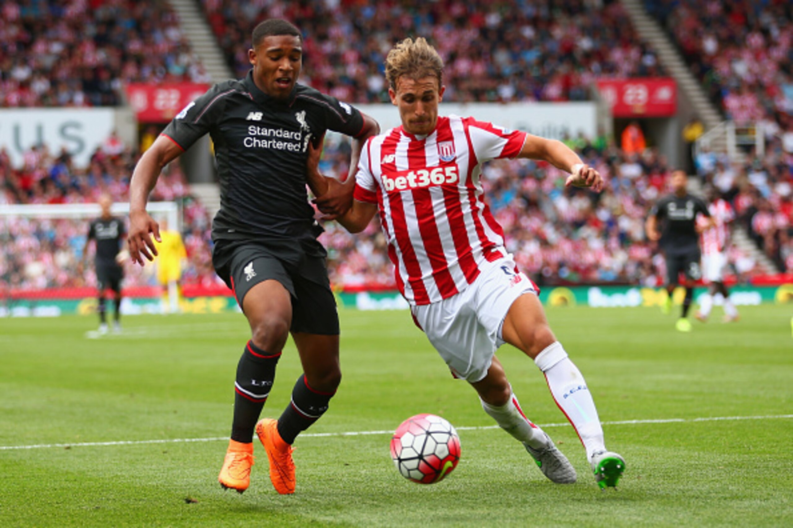 STOKE ON TRENT, ENGLAND - AUGUST 09: Jordon Ibe of Liverpool and Marc Muniesa of Stoke City battle for the ball during the Barclays Premier League match between Stoke City and Liverpool at Brittania Stadium on August 9, 2015 in Stoke on Trent, England. STOKE ON TRENT, ENGLAND - AUGUST 09: Jordon Ibe of Liverpool and Marc Muniesa of Stoke City battle for the ball during the Barclays Premier League match between Stoke City and Liverpool at Brittania Stadium on August 9, 2015 in Stoke on Trent, England.