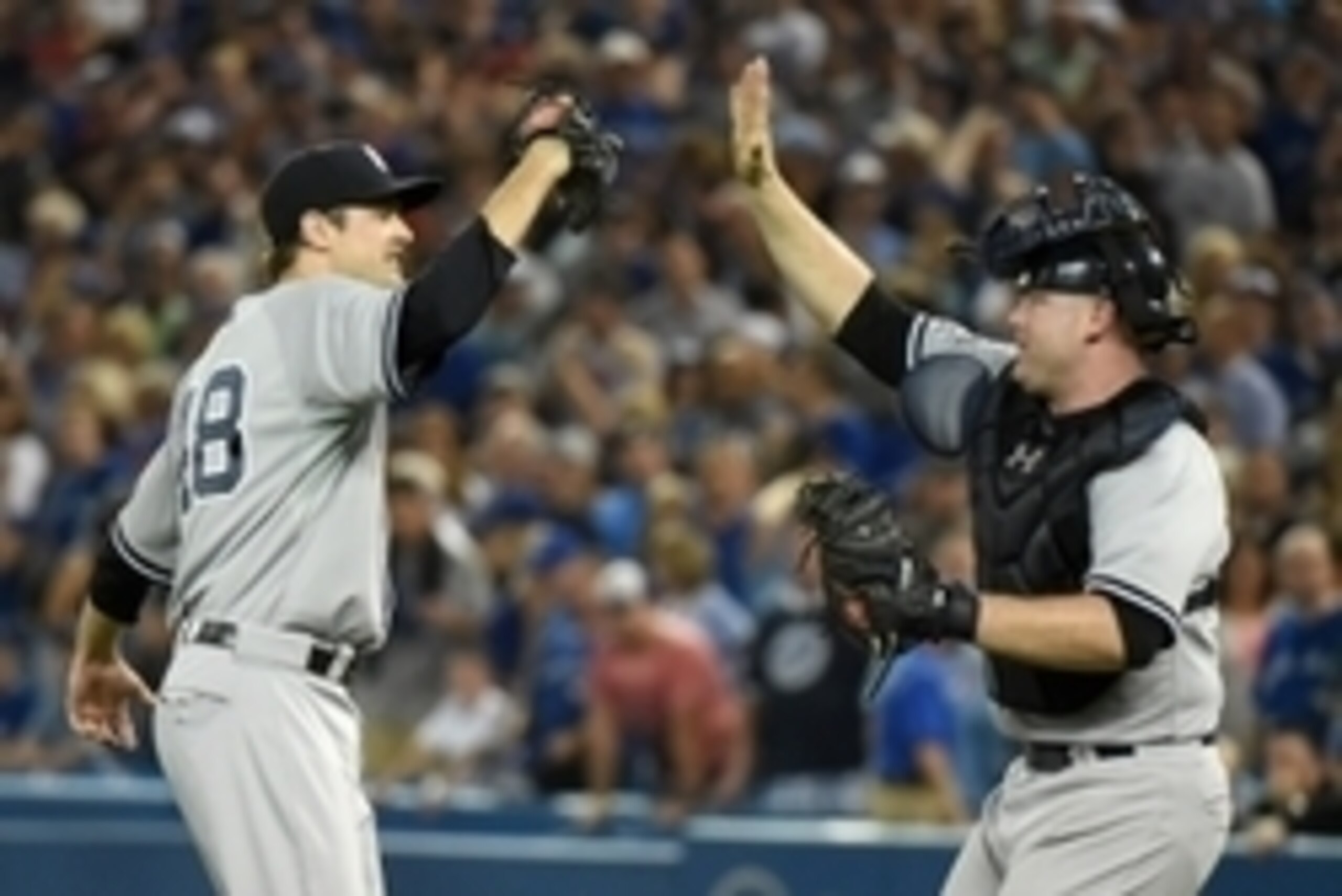 Aug 14, 2015; Toronto, Ontario, CAN;  New York Yankees relief pitcher Andrew Miller (48) high fives with catcher Brian McCann (34) as they celebrate a 4-3 win over the Toronto Blue Jays at Rogers Centre. Mandatory Credit: Dan Hamilton-USA TODAY Sports