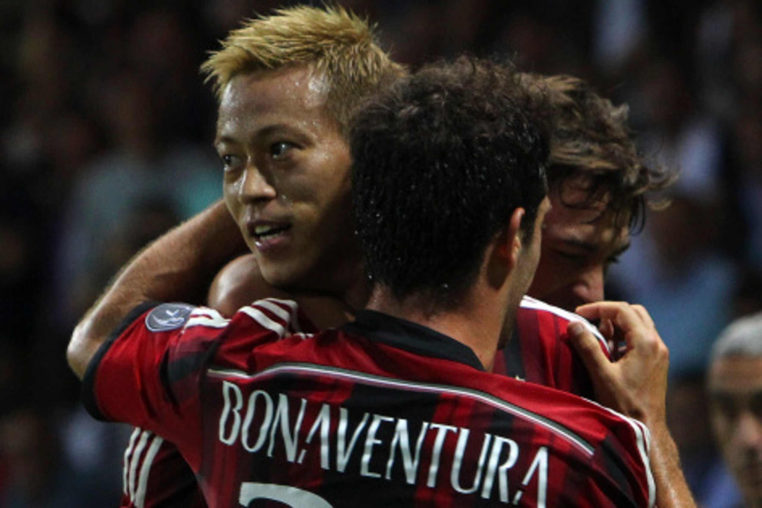 PARMA, ITALY - SEPTEMBER 14:  Keisuke Honda of AC Milan celebrates with his team-mate Giacomo Bonaventura after scoring the opening goal during the Serie A match between Parma FC and AC Milan at Stadio Ennio Tardini on September 14, 2014 in Parma, Italy. 