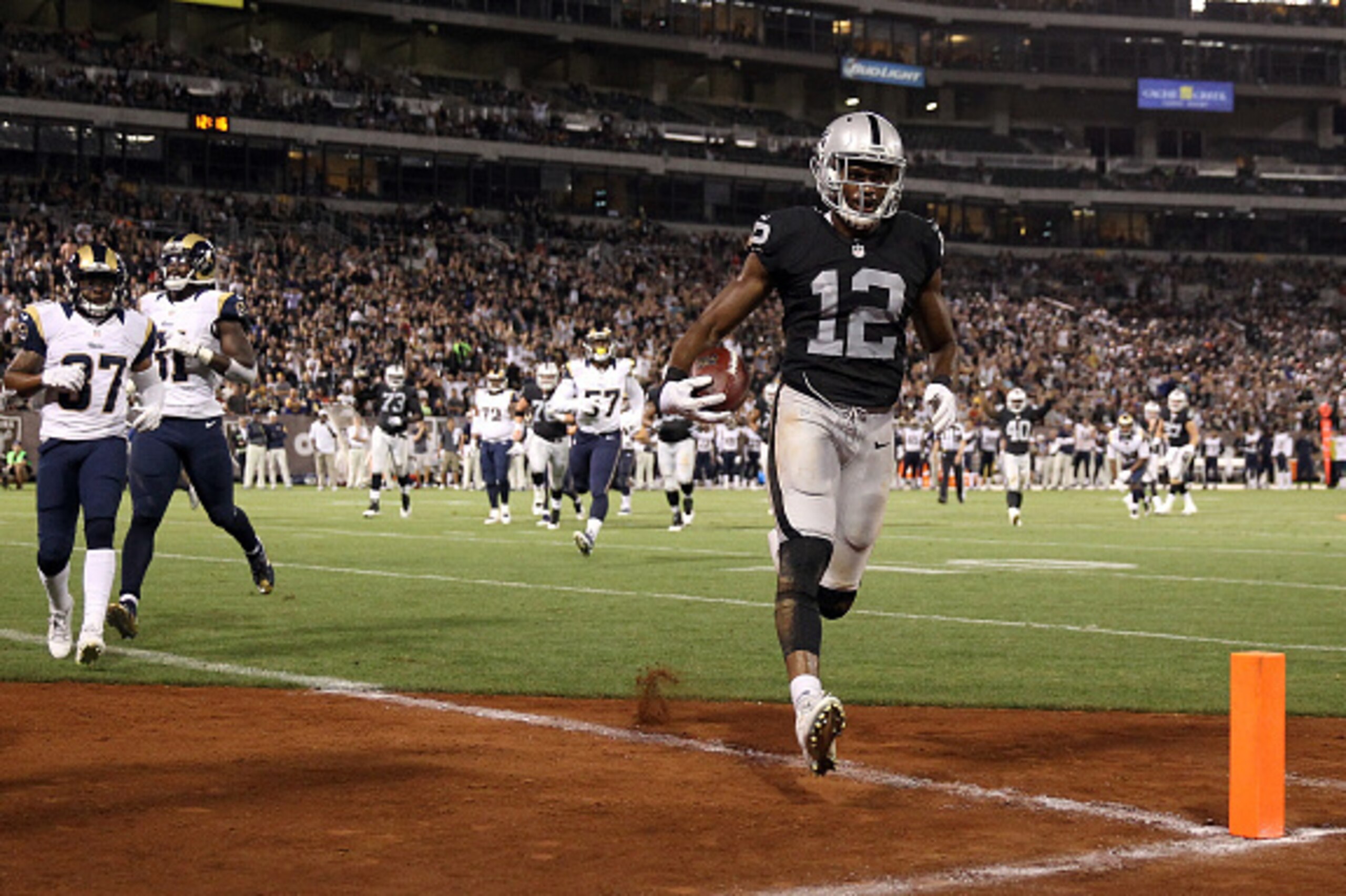 OAKLAND, CA - AUGUST 14:  Brice Butler #12 of the Oakland Raiders runs in for a touchdown against the St. Louis Rams at O.co Coliseum on August 14, 2015 in Oakland, California.  (Photo by Ezra Shaw/Getty Images)