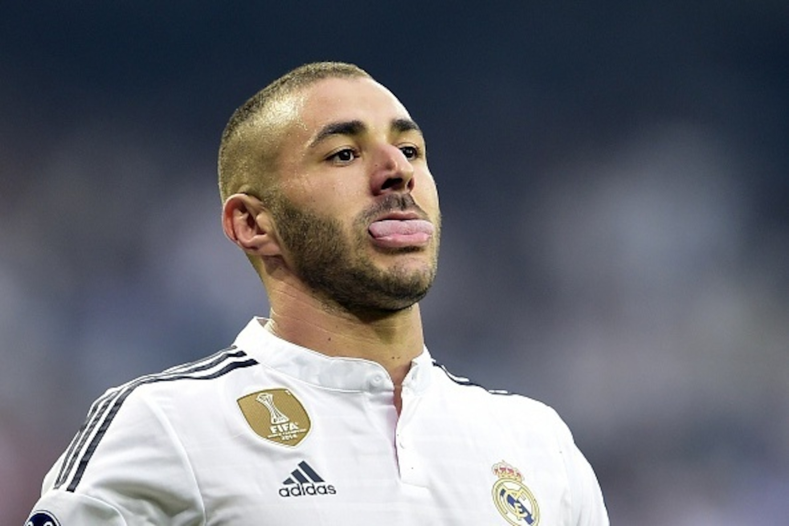 Real Madrid's French forward Karim Benzema sticks out his tongue during the UEFA Champions League semi-final second leg football match Real Madrid FC vs Juventus at the Santiago Bernabeu stadium in Madrid on May 13, 2015.   AFP PHOTO/ GERARD JULIEN       