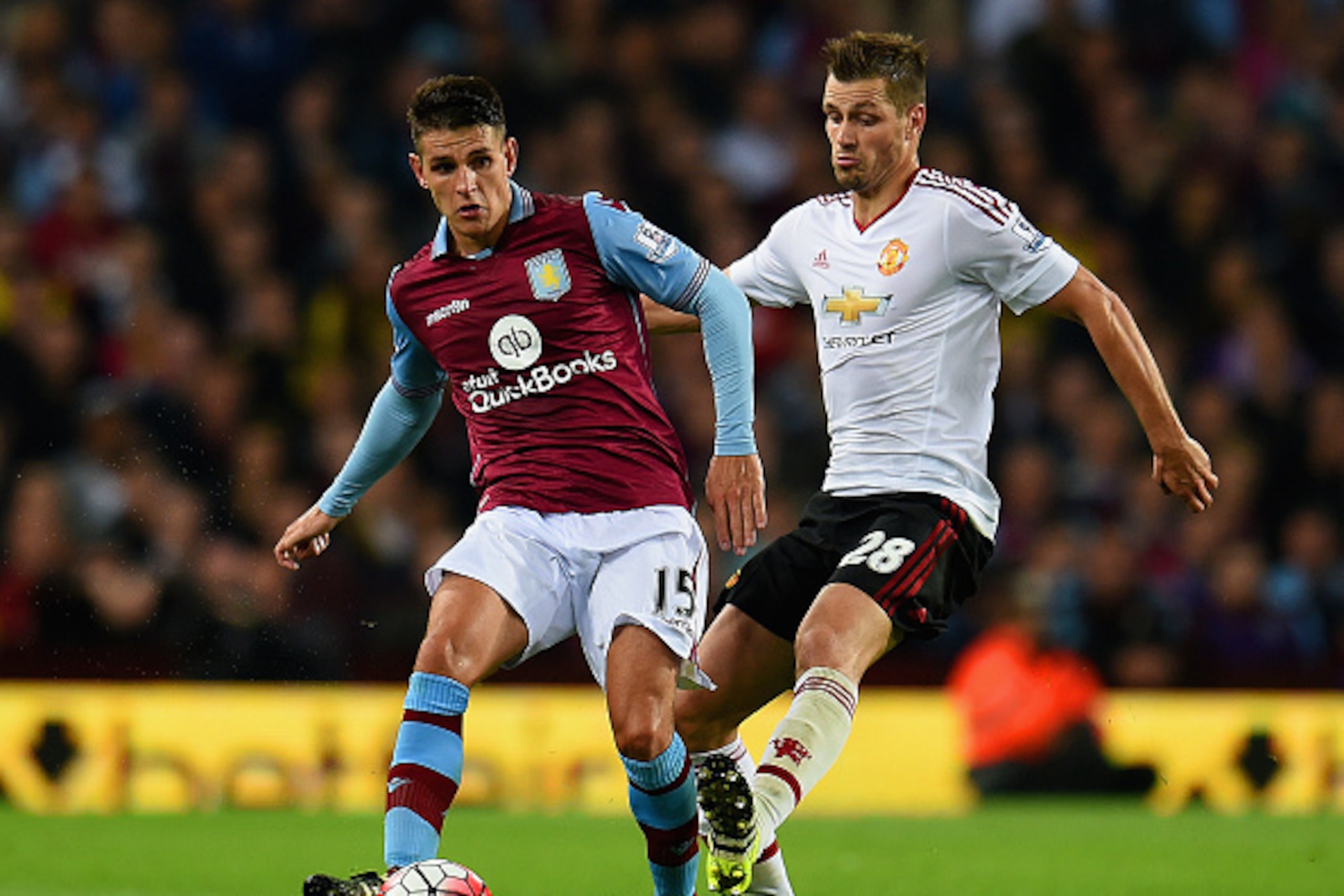 BIRMINGHAM, ENGLAND - AUGUST 14:  Ashley Westwood of Aston Villa is tackled by Morgan Schneiderlin of Manchester United during the Barclays Premier League match between Aston Villa and Manchester United on August 14, 2015 in Birmingham, United Kingdom.  (
