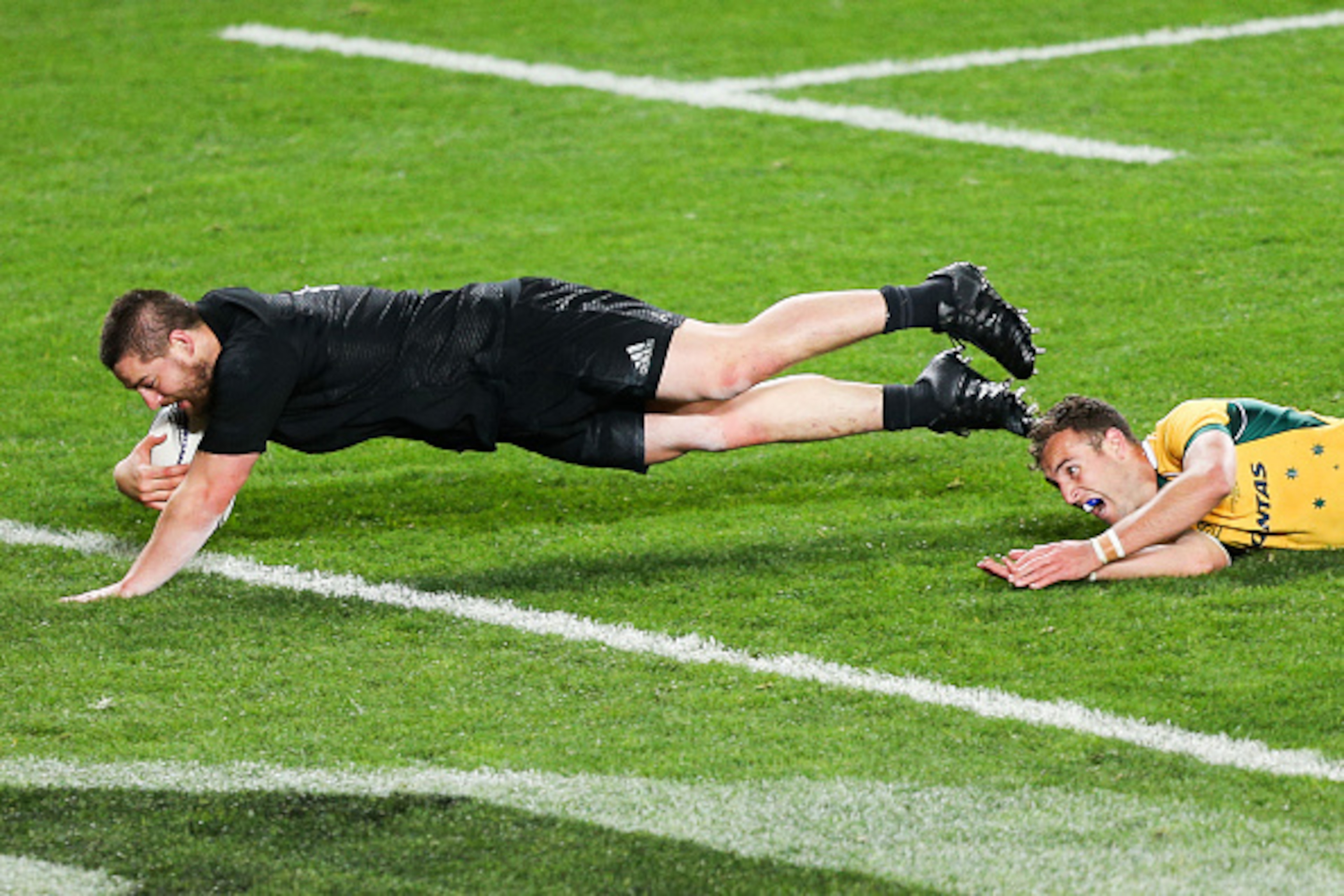AUCKLAND, NEW ZEALAND - AUGUST 15:  Dane Coles of the All Blacks beats the tackle of Nic White of the Wallabies to score a try during The Rugby Championship, Bledisloe Cup match between the New Zealand All Blacks and the Australian Wallabies at Eden Park 
