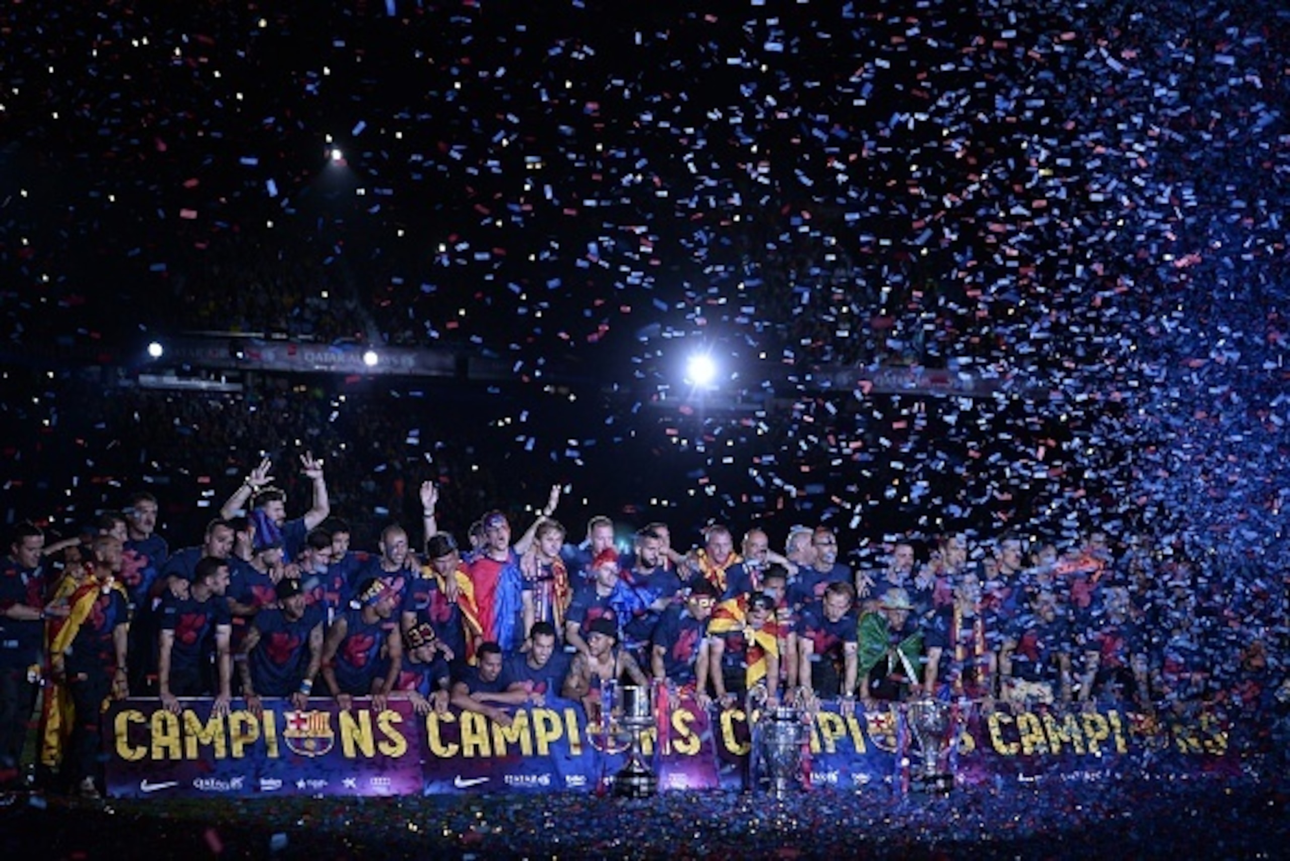 Barcelona players pose with the three trophies as they take part in the celebrations held for their victory over Juventus, one day after the UEFA Champions League final football, at the Camp Nou stadium in Barcelona on June 7, 2015. Luis Suarez and Neymar