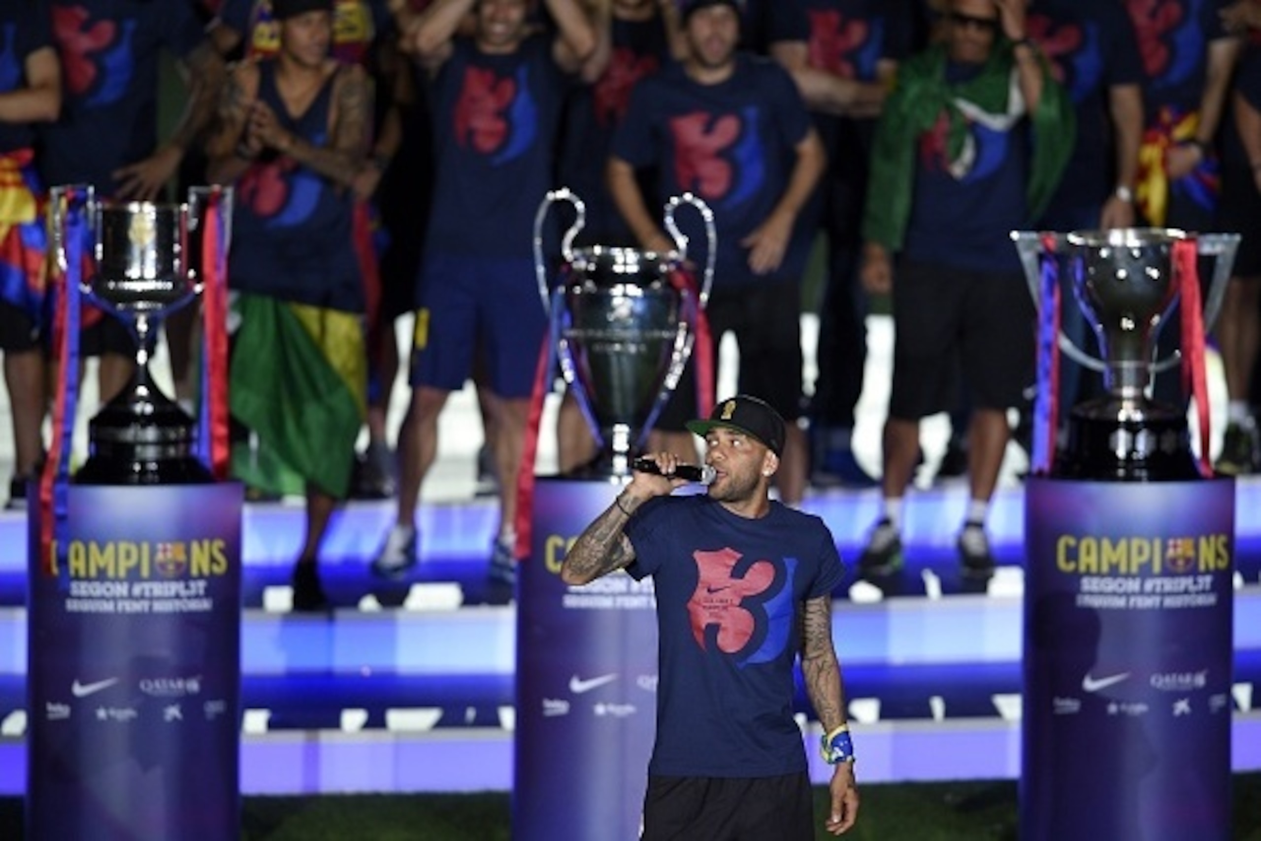 Barcelona's Brazilian defender Dani Alves delivers a speech as he takes part in the celebrations held for their victory over Juventus, one day after the UEFA Champions League final football, at the Camp Nou stadium in Barcelona on June 7, 2015. Luis Suare