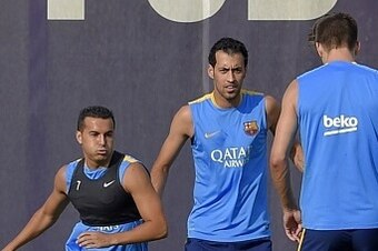 Barcelona's forward Pedro Rodriguez (L), Barcelona's midfielder Sergio Busquets (C) and Barcelona's defender Gerard Pique (R) take part in a training session at the Sports Center FC Barcelona Joan Gamper in Sant Joan Despi, near Barcelona on July 15, 2015