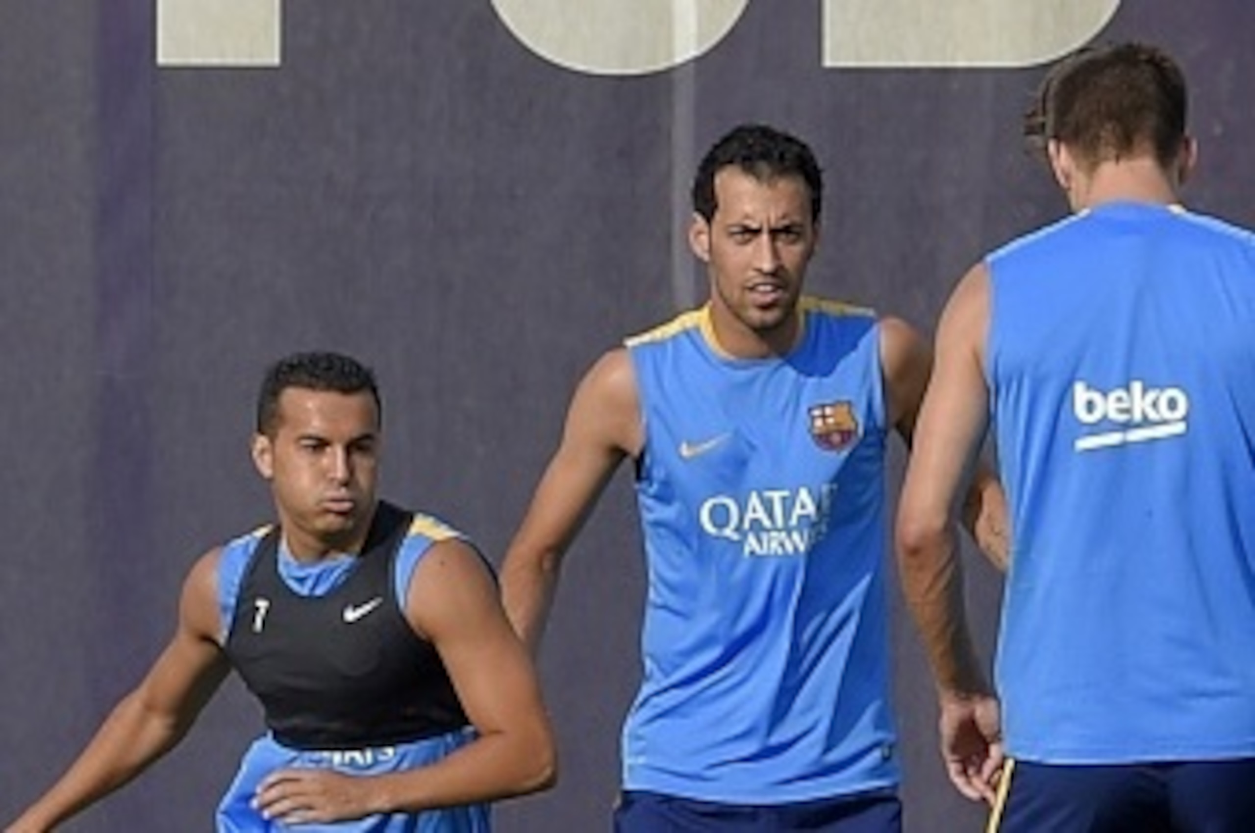 Barcelona's forward Pedro Rodriguez (L), Barcelona's midfielder Sergio Busquets (C) and Barcelona's defender Gerard Pique (R) take part in a training session at the Sports Center FC Barcelona Joan Gamper in Sant Joan Despi, near Barcelona on July 15, 2015