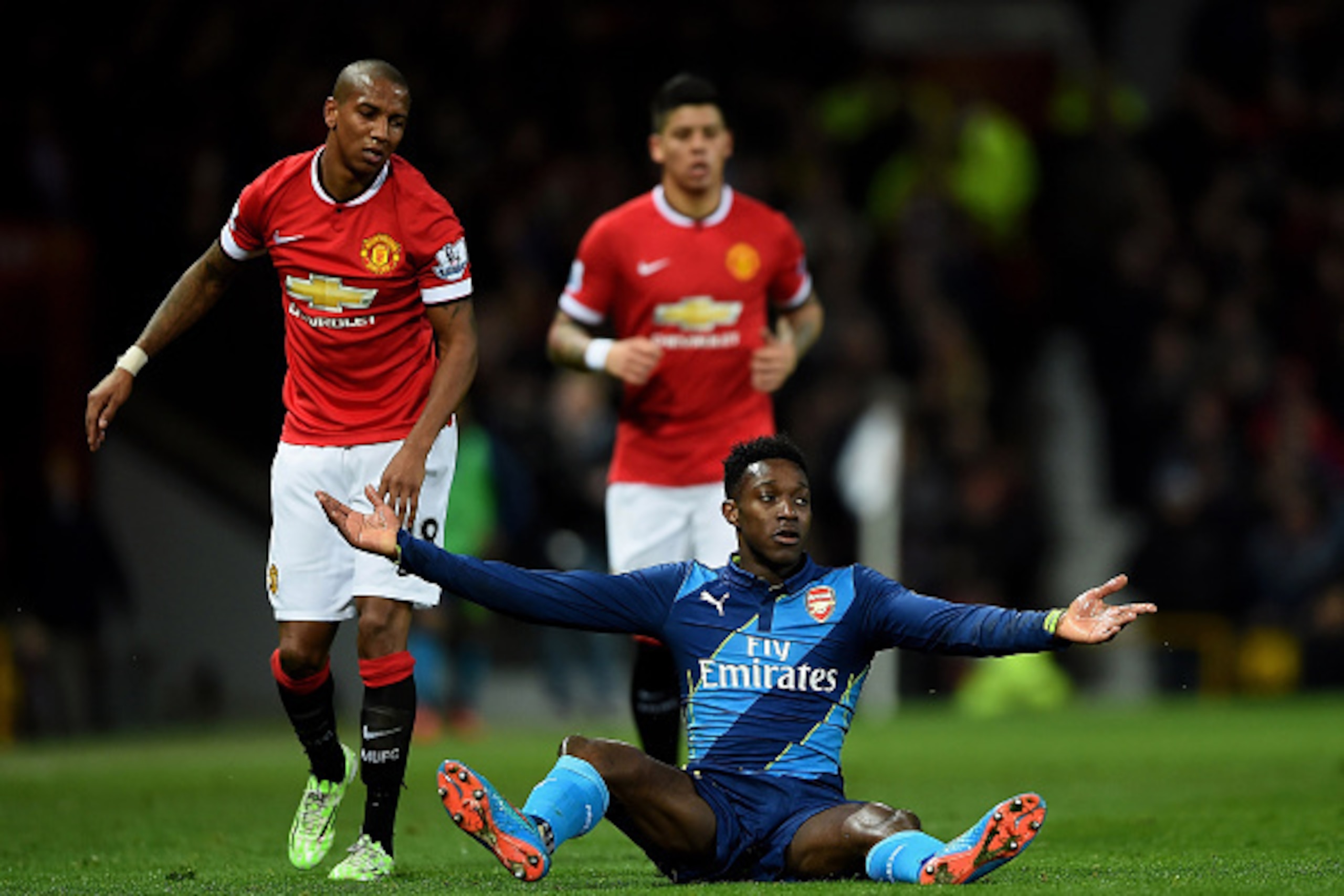 MANCHESTER, ENGLAND - MARCH 09:  Danny Welbeck of Arsenal recats after being brought down by Ashley Young of Manchester United during the FA Cup Quarter Final match between Manchester United and Arsenal at Old Trafford on March 9, 2015 in Manchester, Engl