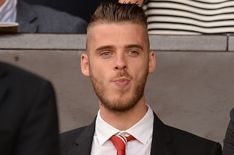 Manchester United's Spanish goalkeeper David de Gea watches from the stands ahead of the English Premier League football match between Manchester United and Tottenham Hotspur at Old Trafford in Manchester, north west England, on August 8, 2015. AFP PHOTO 