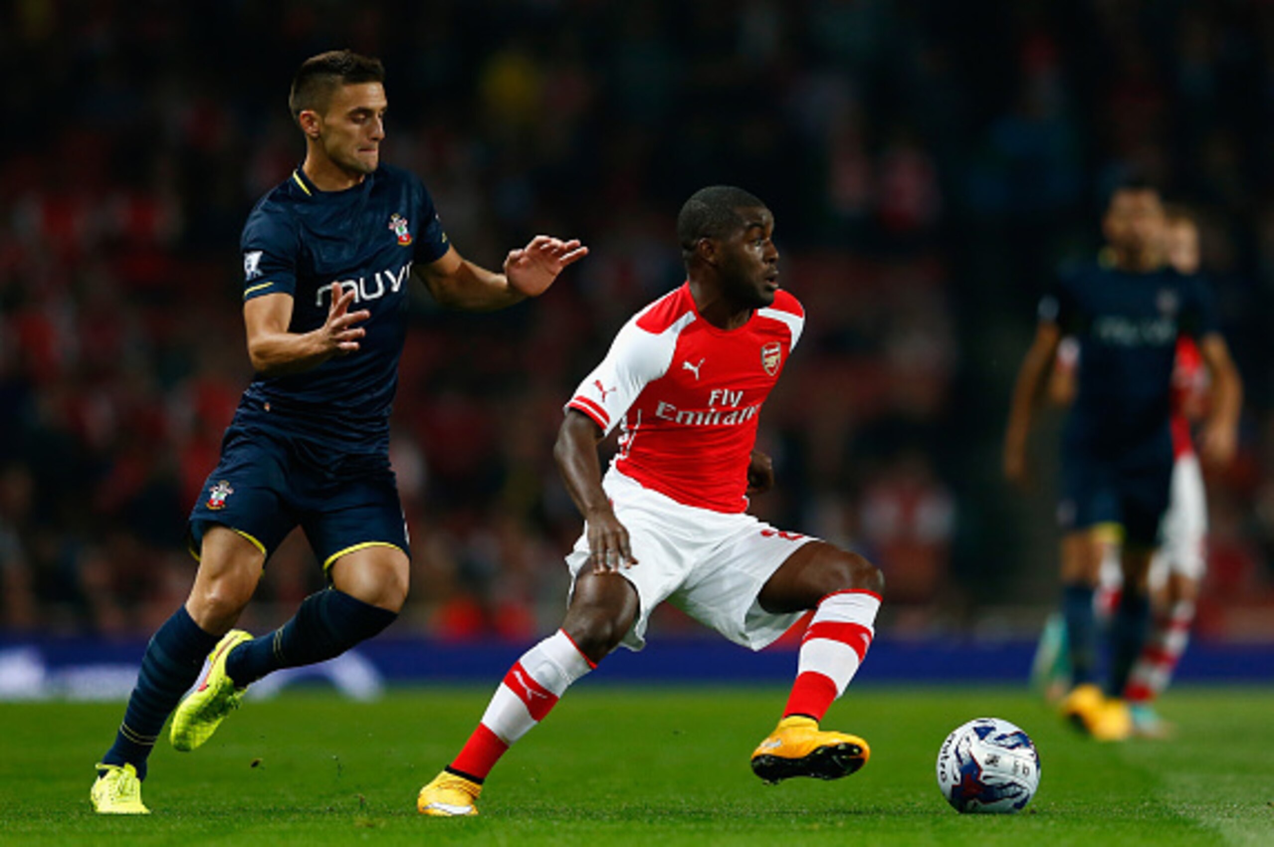 LONDON, ENGLAND - SEPTEMBER 23:  Joel Campbell of Arsenal battles with Dusan Tadic of Southampton during the Capital One Cup Third Round match between Arsenal and Southampton at the Emirates Stadium on September 23, 2014 in London, England.  (Photo by Jul