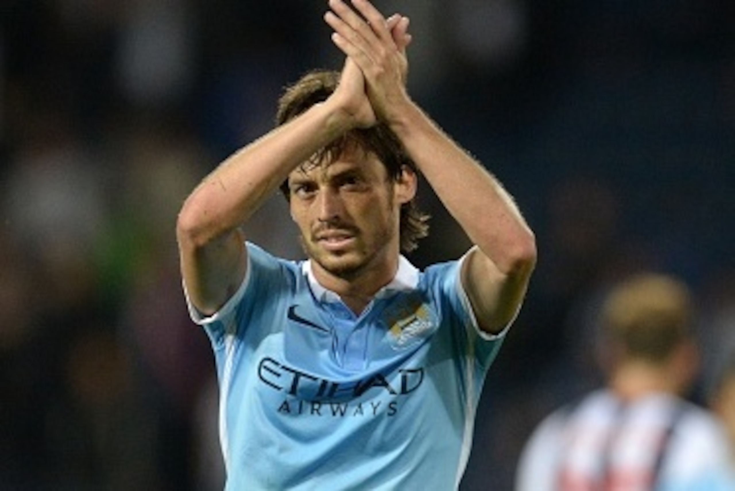 Manchester City's Spanish midfielder David Silva applauds fans after winning the English Premier League football match between West Bromwich Albion and Manchester City at The Hawthorns in West Bromwich, central England, on August 10, 2015.
AFP PHOTO / OLI