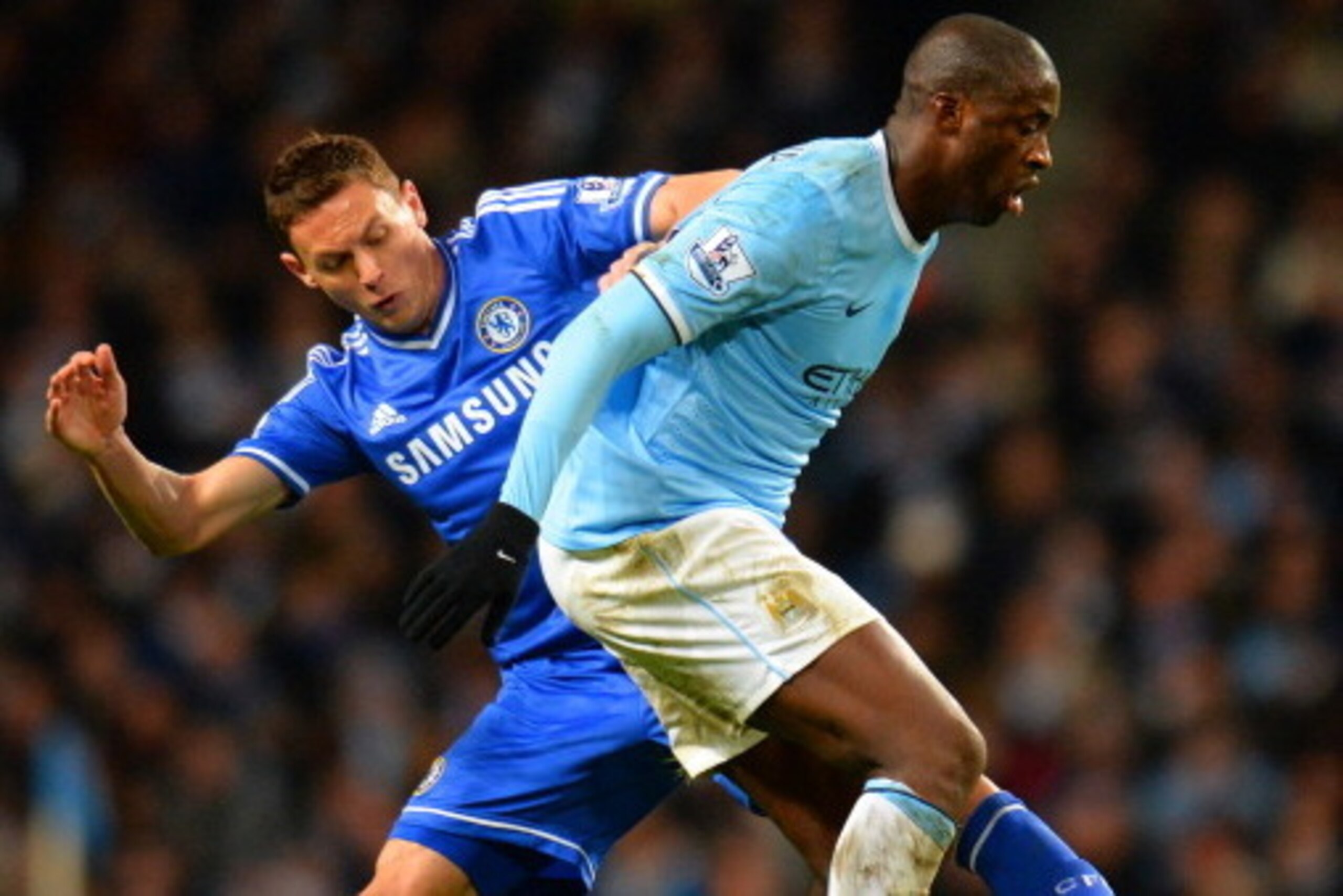 MANCHESTER, ENGLAND - FEBRUARY 03:  Nemanja Matic of Chelsea tackles Yaya Toure of Manchester City during the Barclays Premier League match between Manchester City and Chelsea at Etihad Stadium on February 3, 2014 in Manchester, England.  (Photo by Shaun 