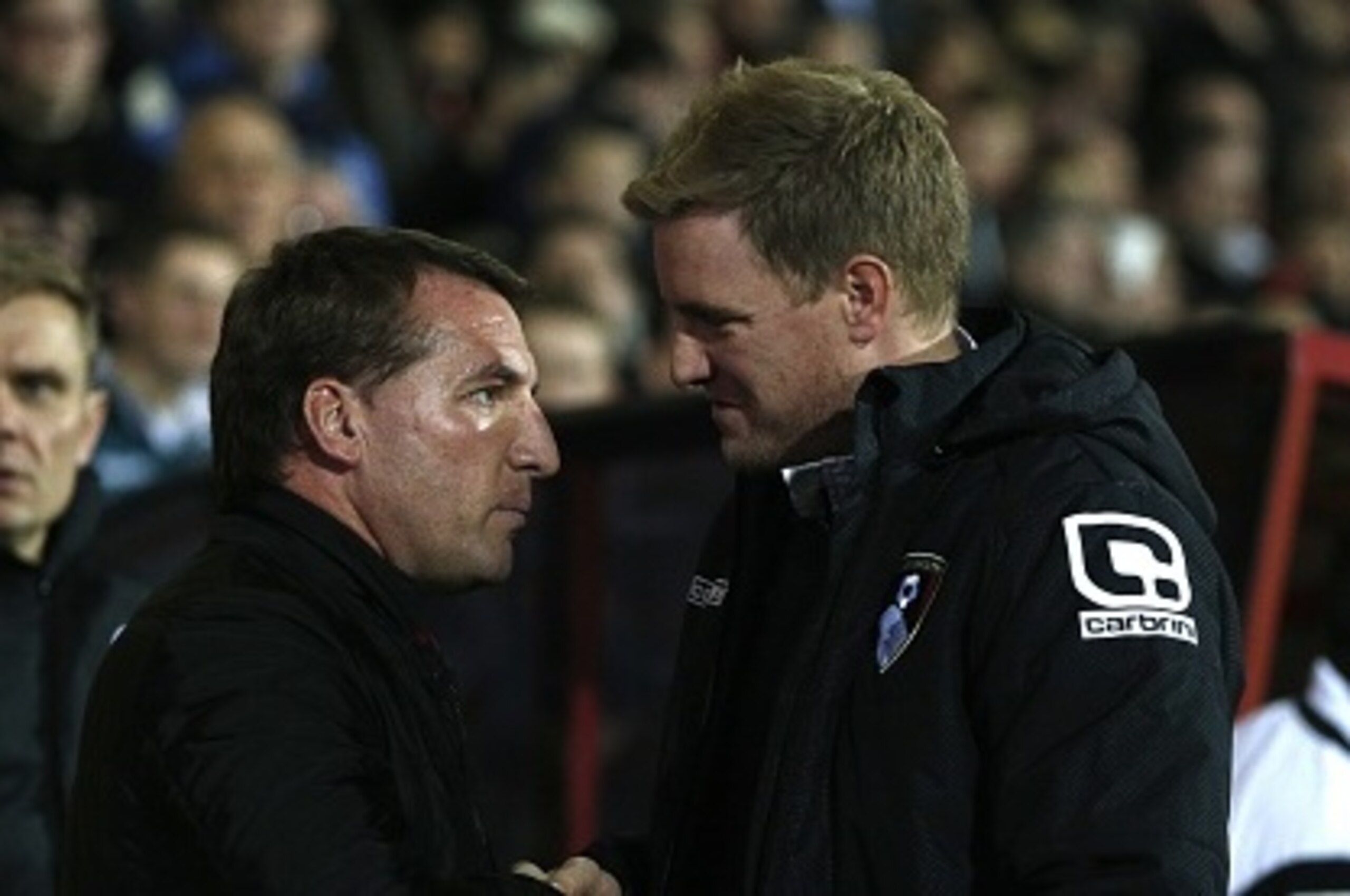Liverpool's Northern Irish manager Brendan Rodgers (L) is greeted by Bournemouth's English manager Eddie Howe (R) before the start of the English League Cup quarter-final football match between Bournemouth and Liverpool at Goldsands Stadium in Bournemouth