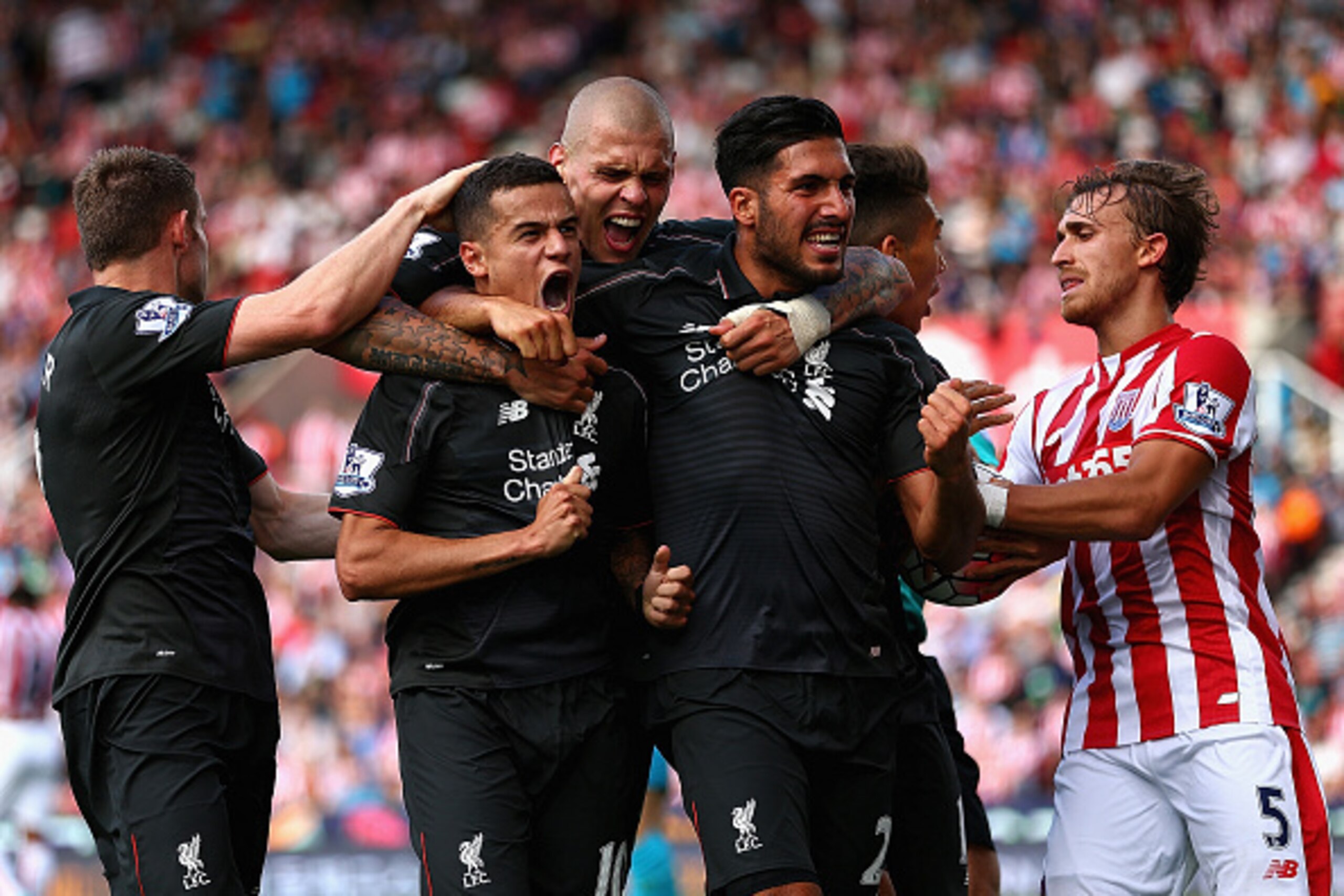 STOKE ON TRENT, ENGLAND - AUGUST 09:  Philippe Coutino of Liverpool celebrates after scoring the winning goal with team mates Emre Can and Martin Skrtel during the Barclays Premier League match between Stoke City and Liverpool at Britannia Stadium on Augu