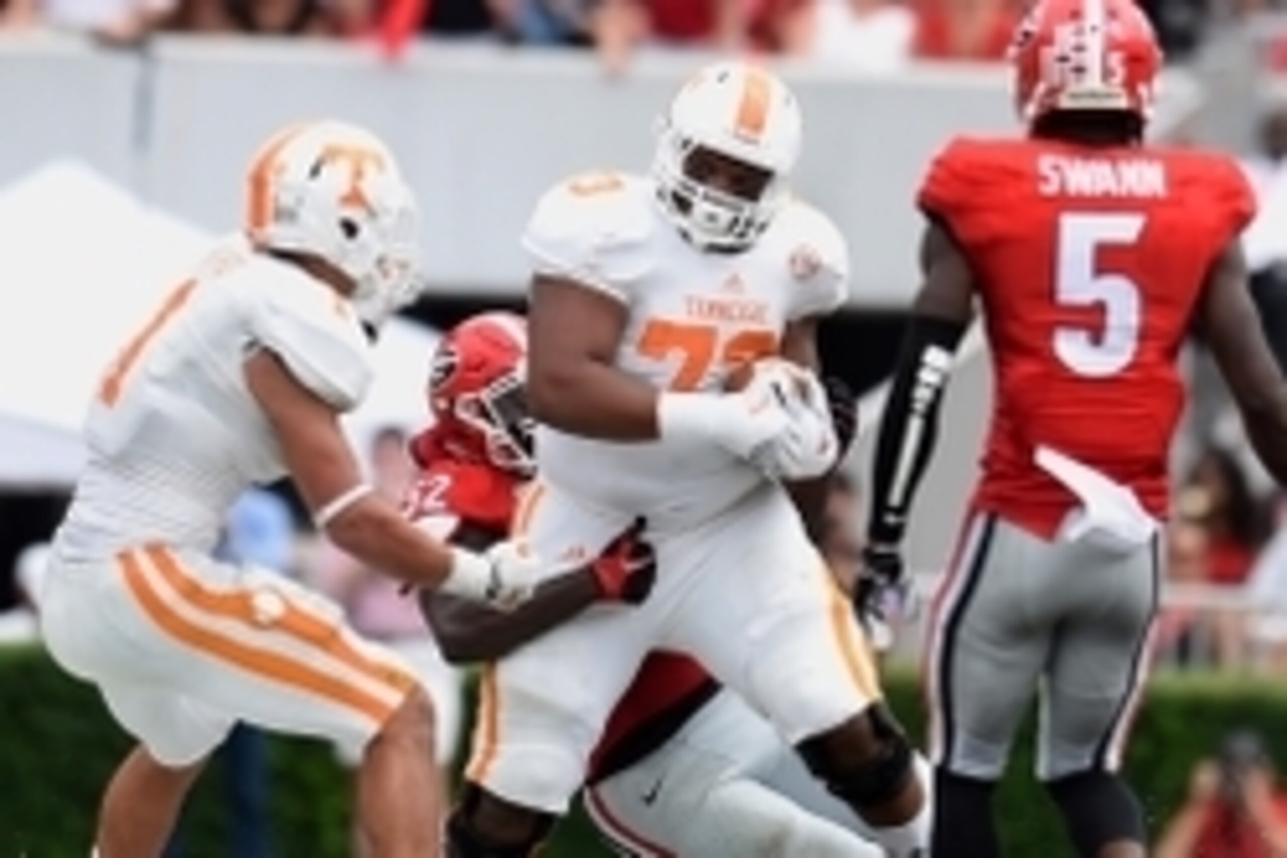 Sep 27, 2014; Athens, GA, USA; Tennessee Volunteers offensive lineman Jashon Robertson (73) is tackled by Georgia Bulldogs linebacker Amarlo Herrera (52) after catching a deflection during the second half at Sanford Stadium. Georgia defeated Tennessee 35-