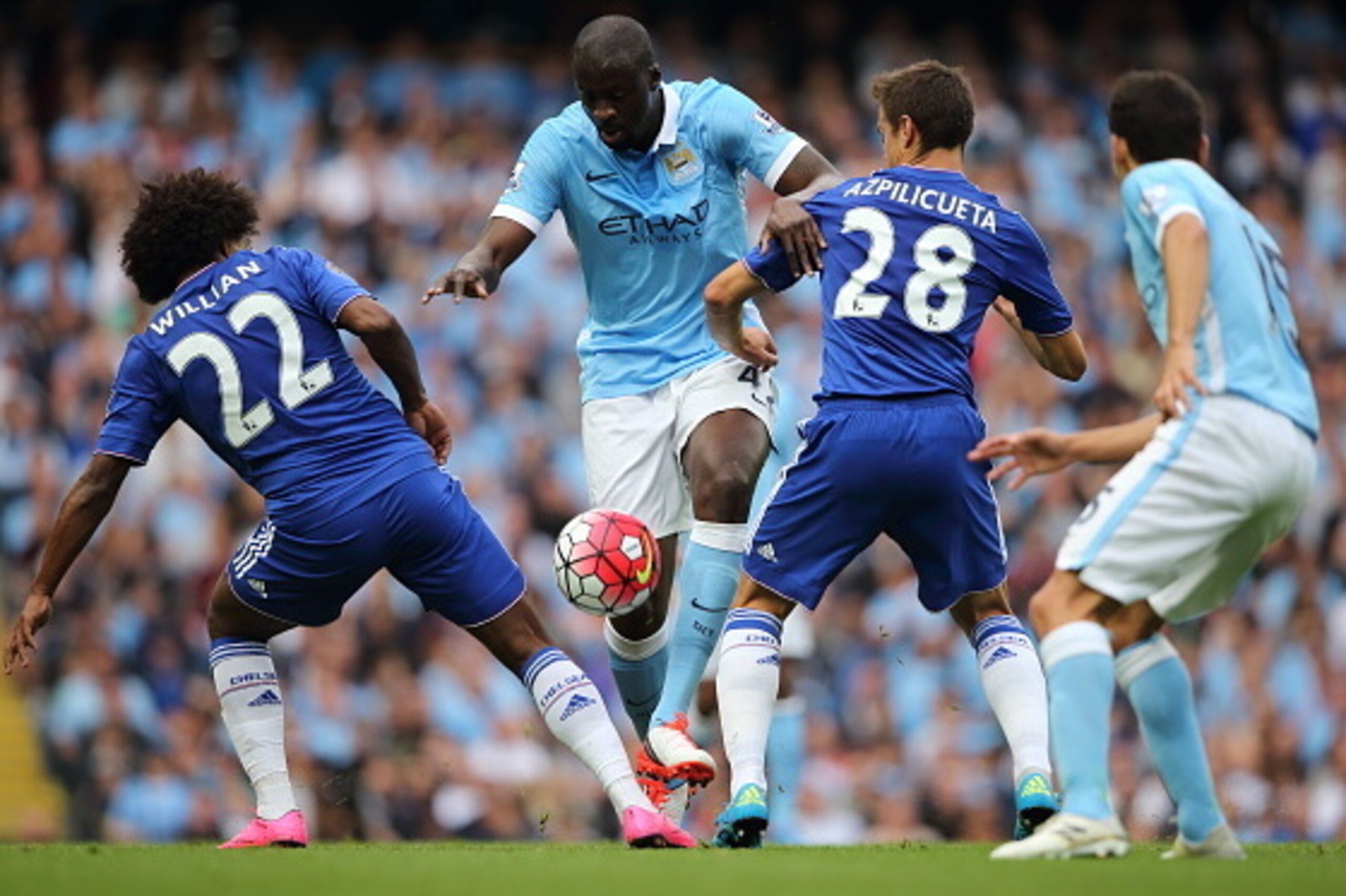 MANCHESTER, ENGLAND - AUGUST 16:  Willian and Cesar Azpilicueta of Chelsea try and stop Yaya Toure of Manchester City during the Barclays Premier League match between Manchester City and Chelsea at the Etihad Stadium on August 16, 2015 in Manchester, Engl