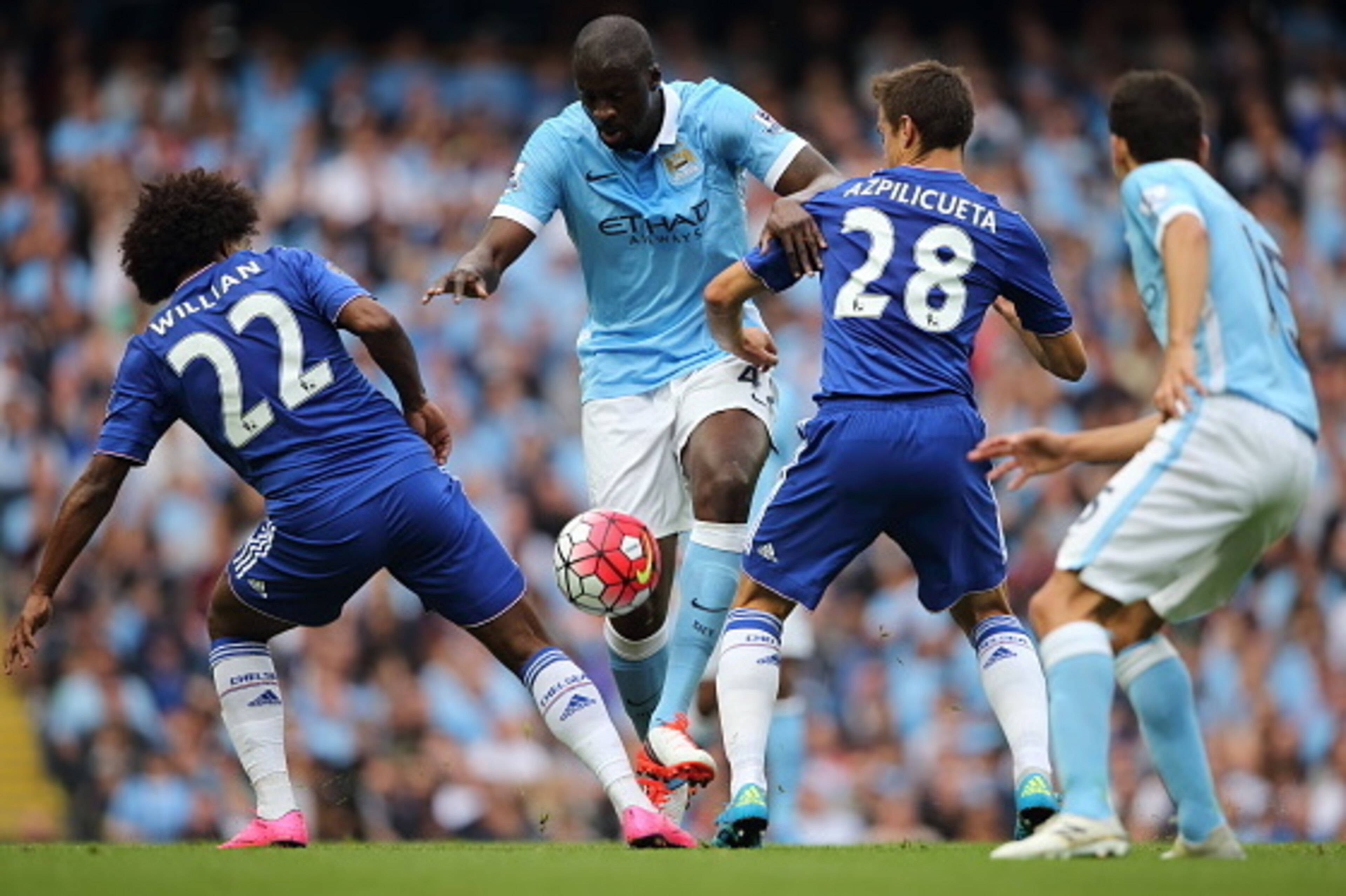 MANCHESTER, ENGLAND - AUGUST 16: Willian and Cesar Azpilicueta of Chelsea try and stop Yaya Toure of Manchester City during the Barclays Premier League match between Manchester City and Chelsea at the Etihad Stadium on August 16, 2015 in Manchester, Engl MANCHESTER, ENGLAND - AUGUST 16: Willian and Cesar Azpilicueta of Chelsea try and stop Yaya Toure of Manchester City during the Barclays Premier League match between Manchester City and Chelsea at the Etihad Stadium on August 16, 2015 in Manchester, Engl